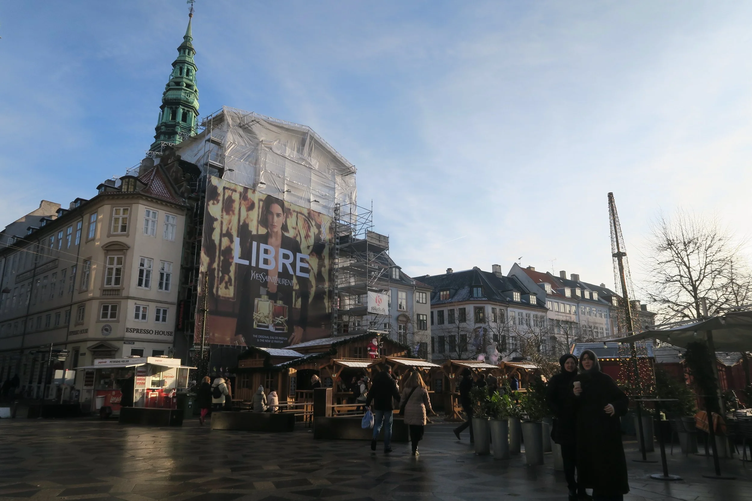 christmas market in copenhagen with green church tower
