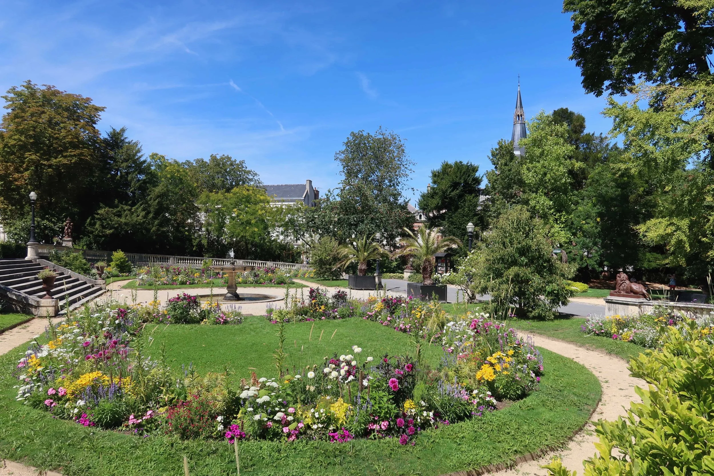quiet peaceful garden with purple yellow and white flowers in a circle
