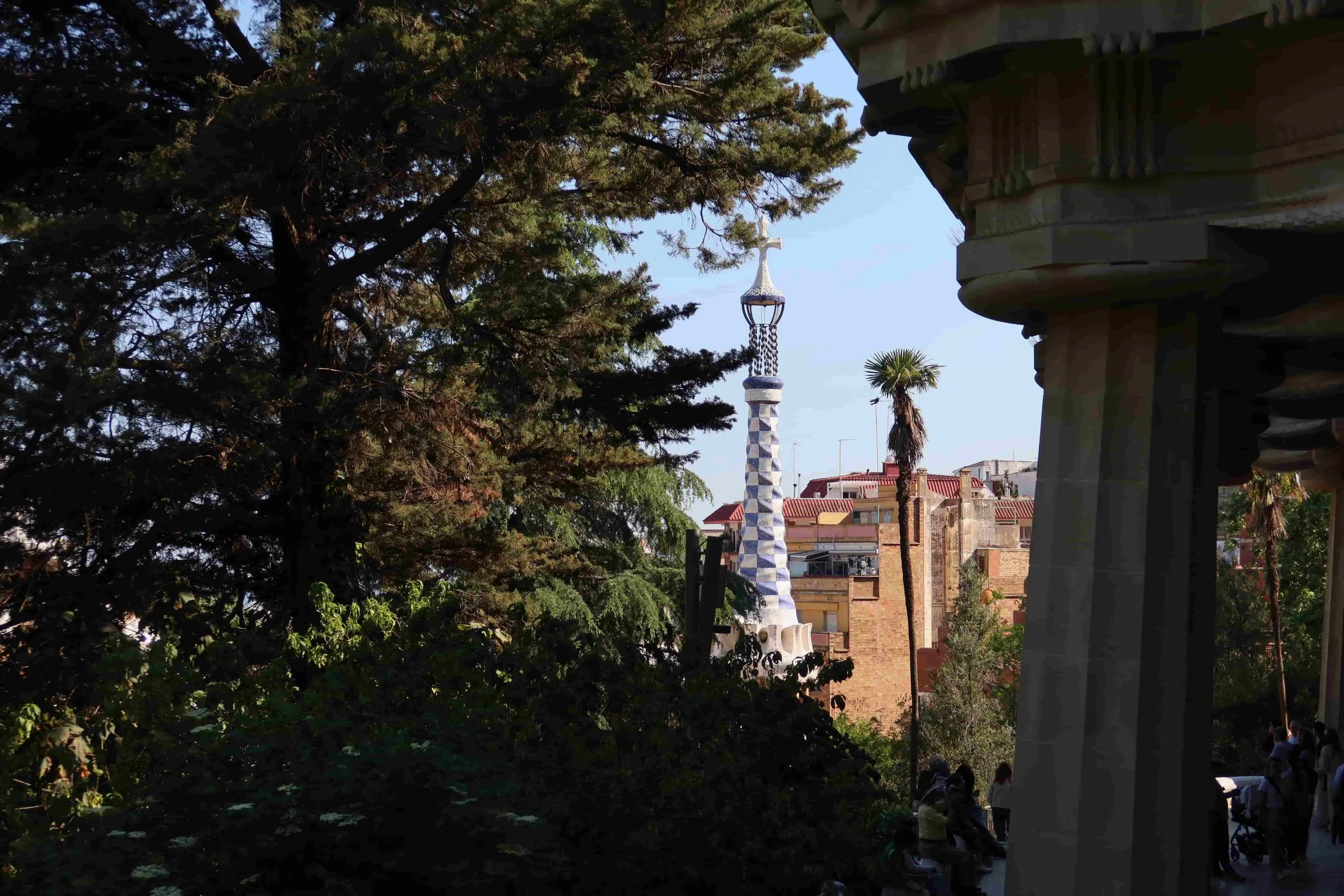 park guell barcelona blue spire green leafy trees