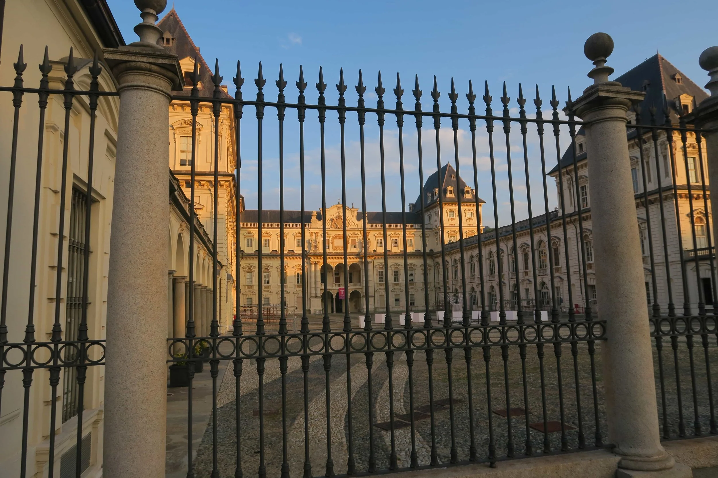 gold palace with black iron gate fences