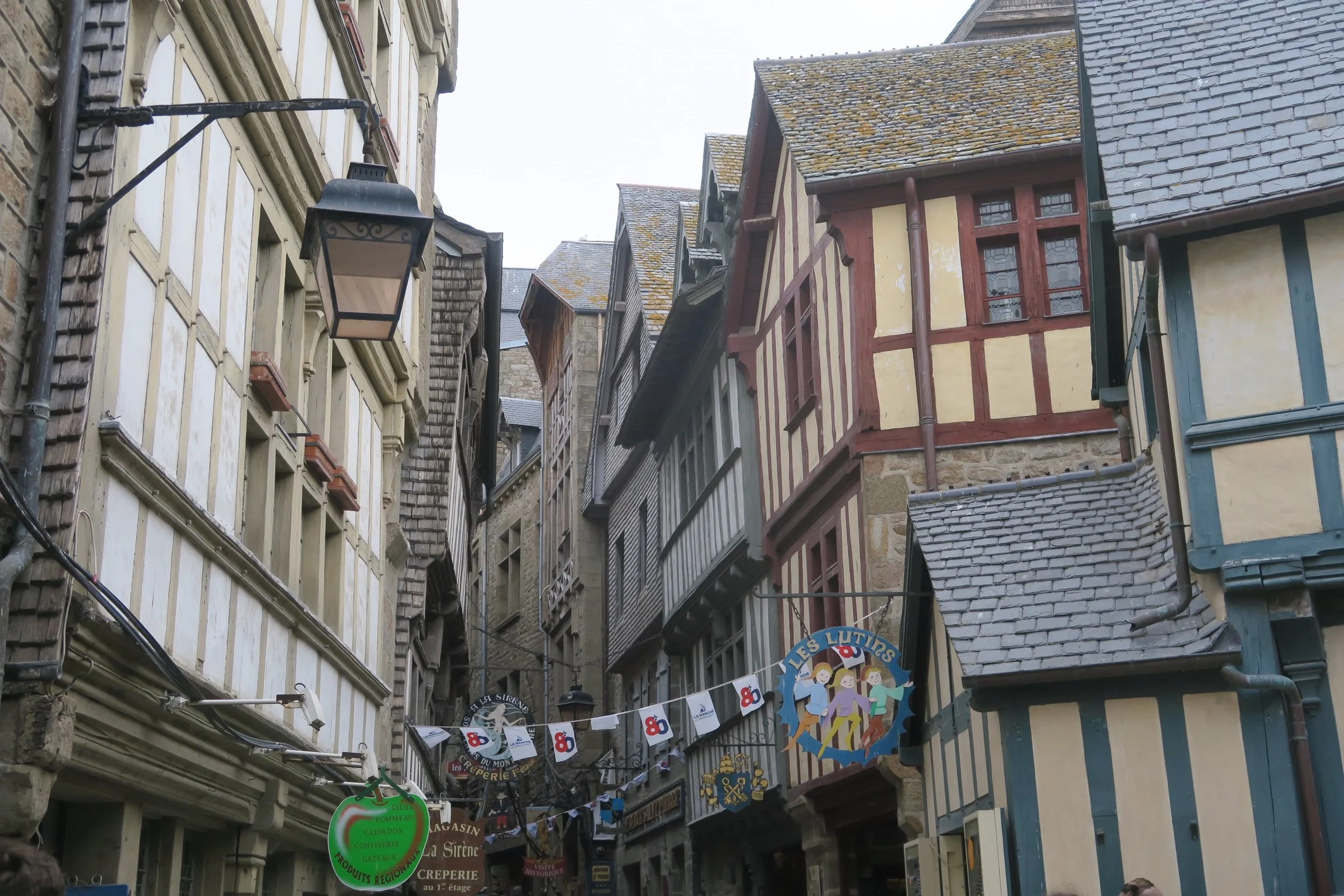old streets in mont saint michel with banners and old german like architecture
