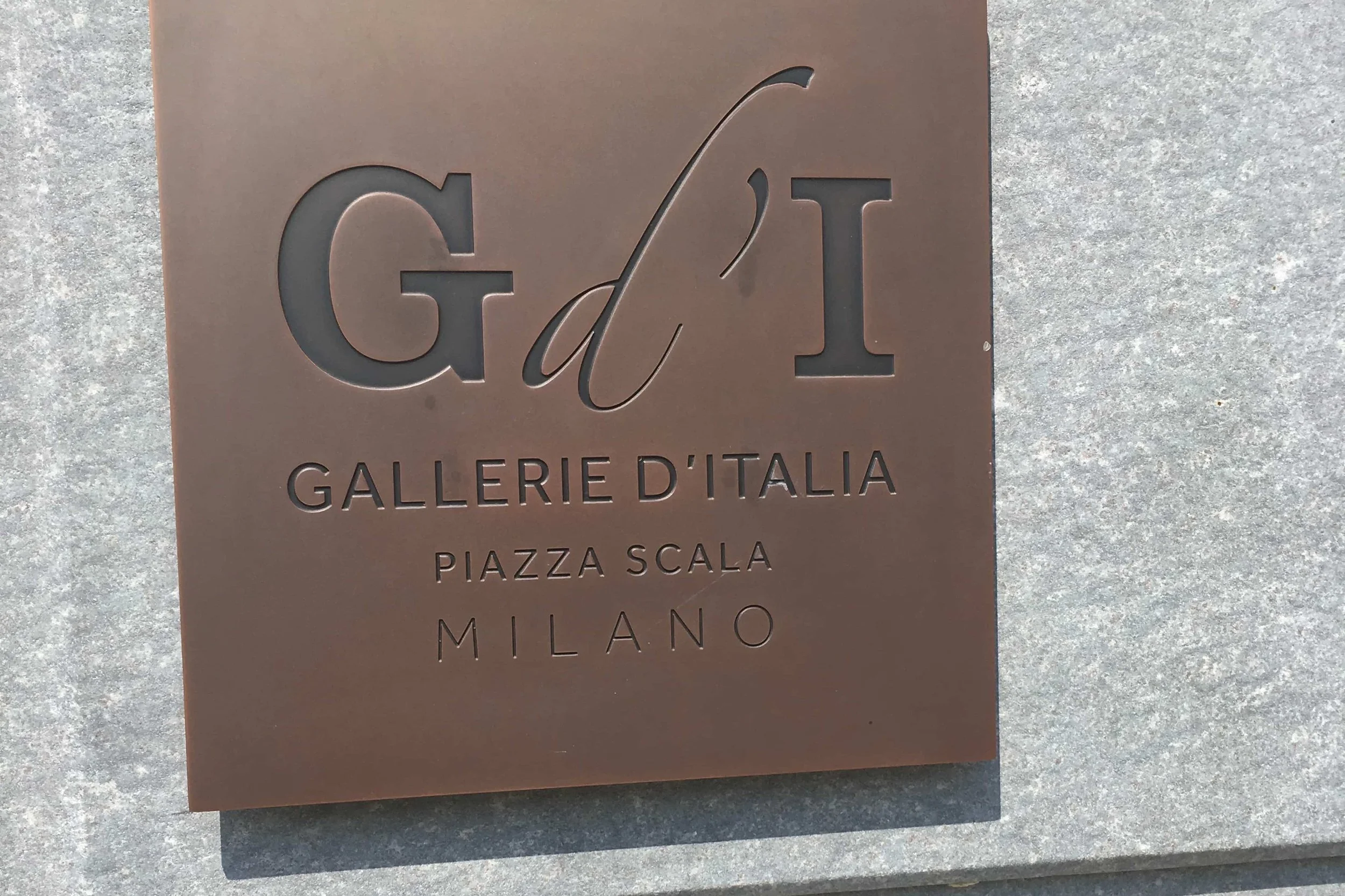 sign outside gallery bronze plaque piazza scala in milan