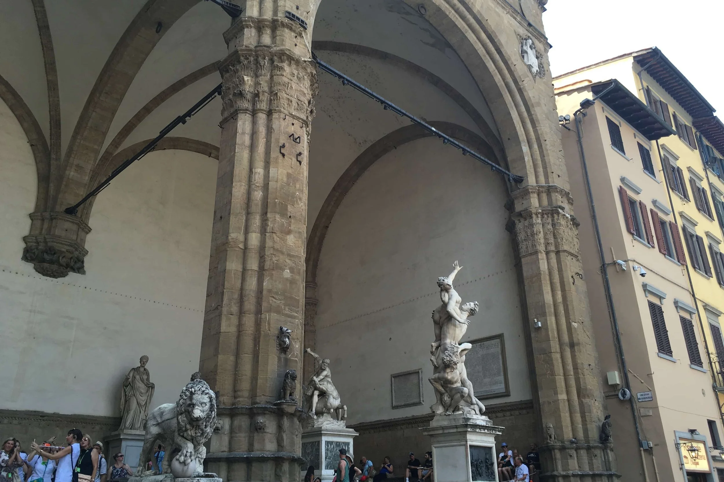 white statues in busy plaza