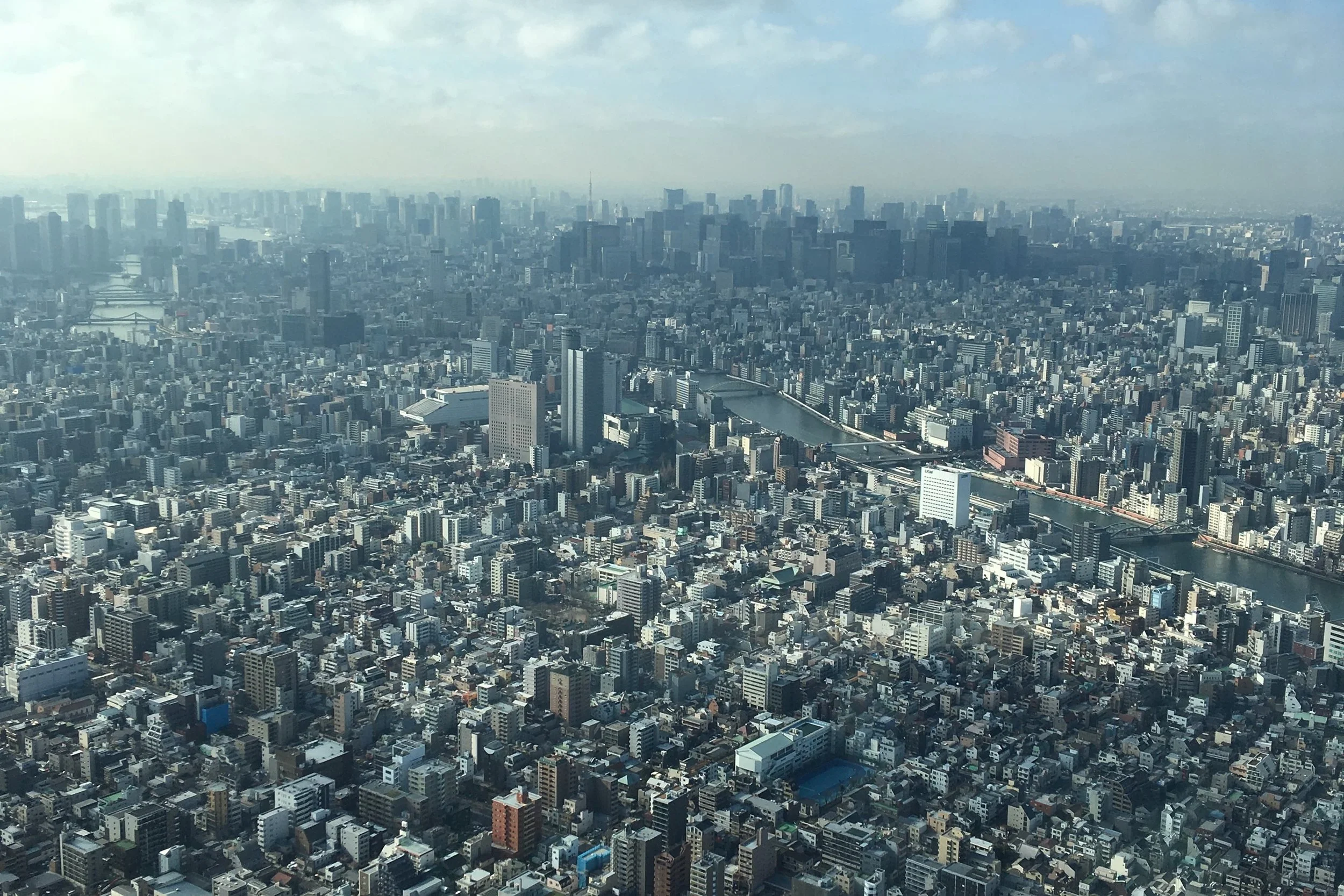 view of tokyo buildings and water crossing through