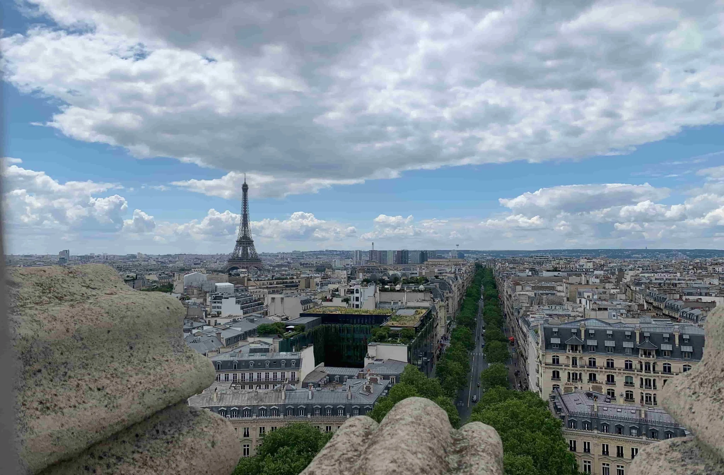 view of paris from the top of the arc de triomphe with eiffel tower on the left