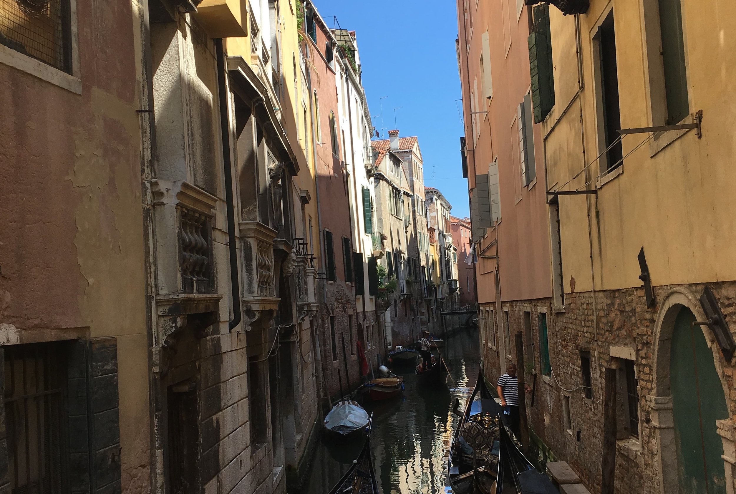 colorful alleys and gondolas lined up in venice