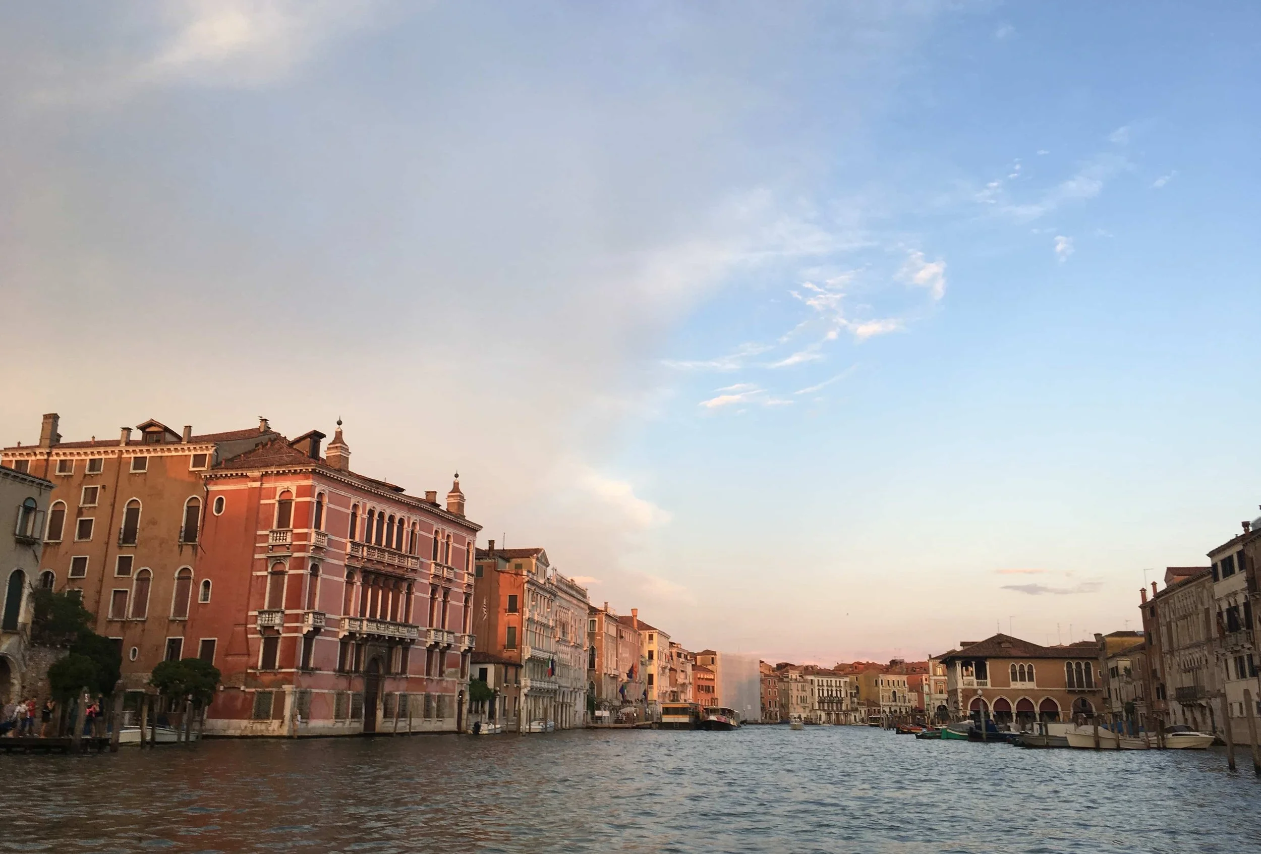 red buildings on water in venice