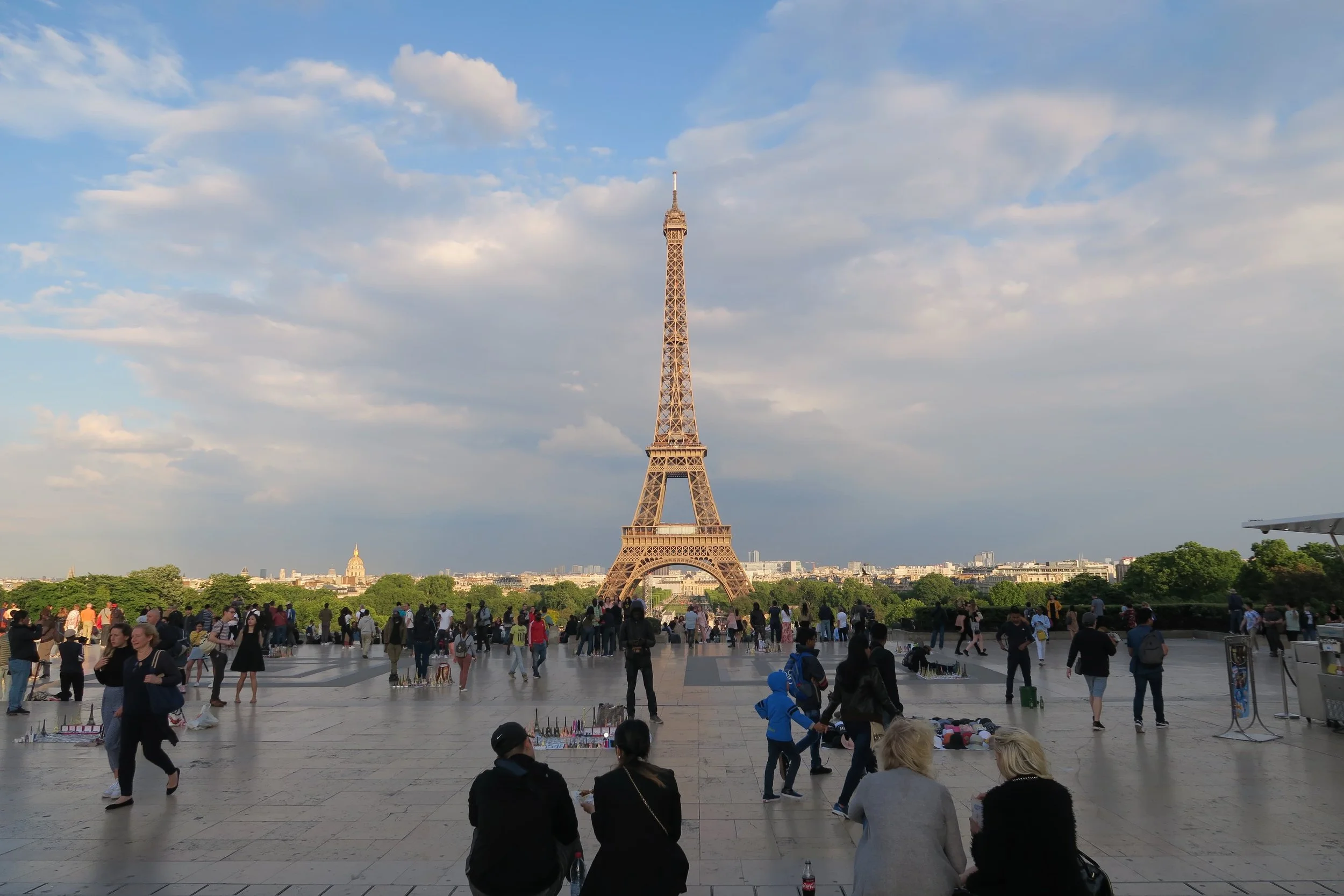 commanding view of eiffel tower golden cloudy day