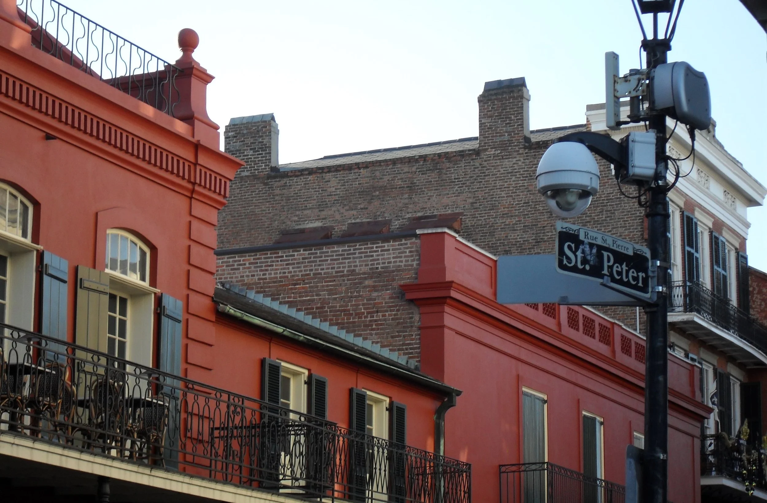 red buildings with black iron gate fences