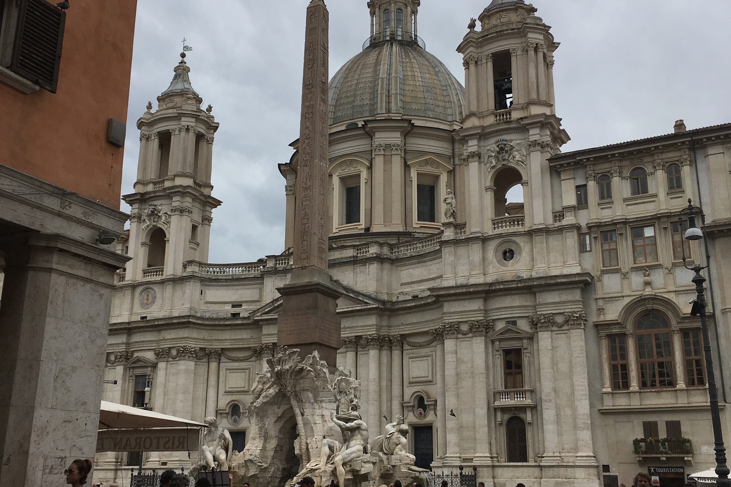 plazza in rome with columns and statues