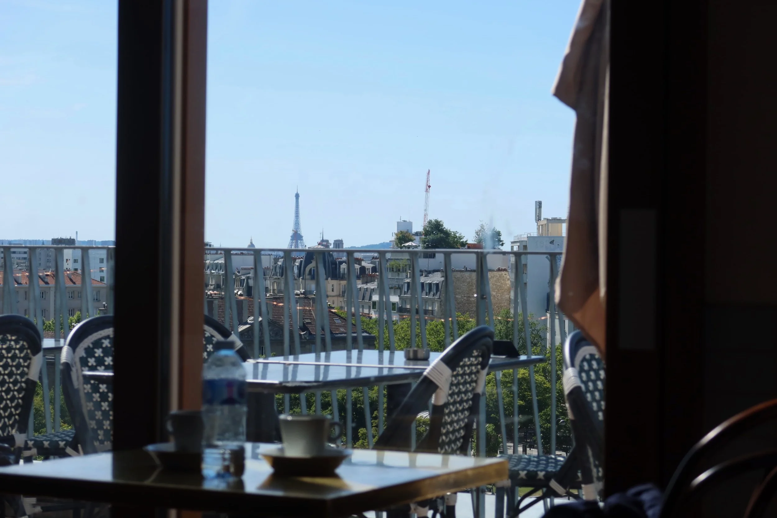 people nation cafe view eiffel tower in distance through the windows