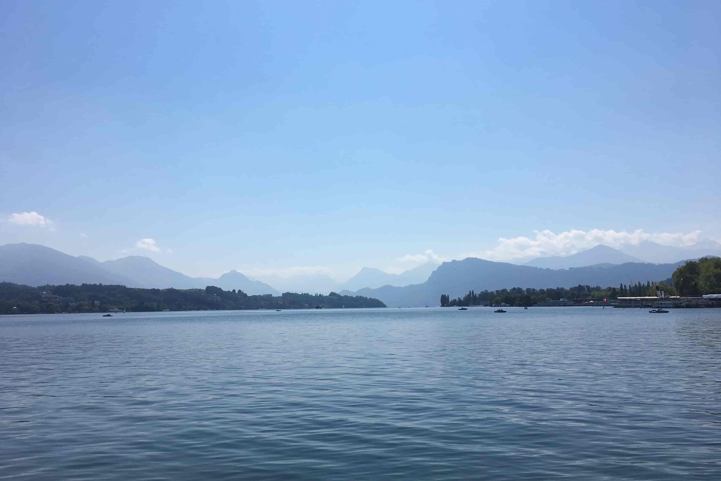 lake lucerne with mountains in the distance blue skies