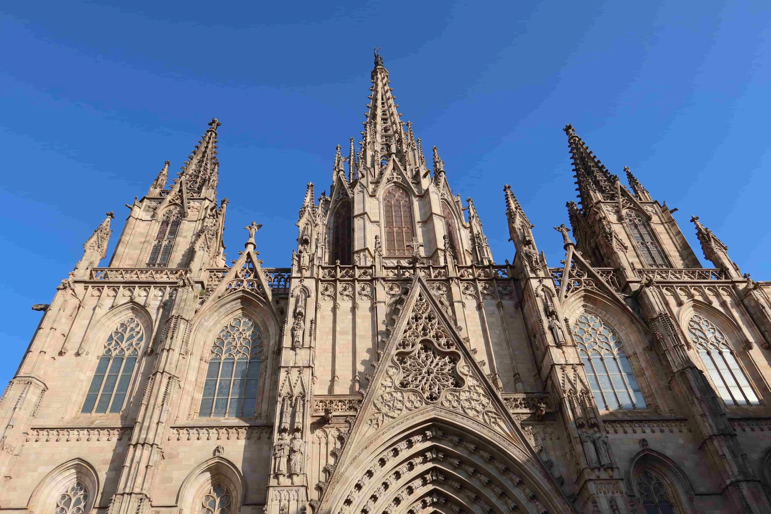 gothic cathedral of barcelona in the blue sky and sun