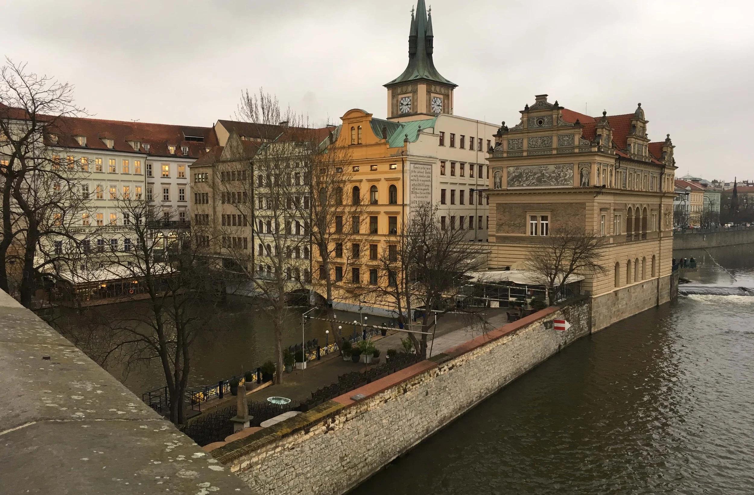 clock tower river and grey view of prague