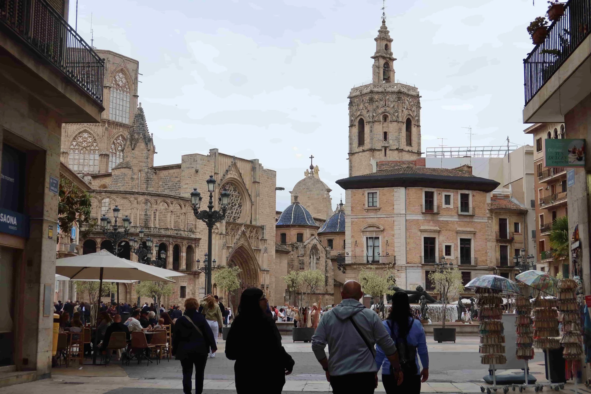 quiet tourists in beautiful european style square with clock tower blue domes old churches fountain cafes and souvenir shops
