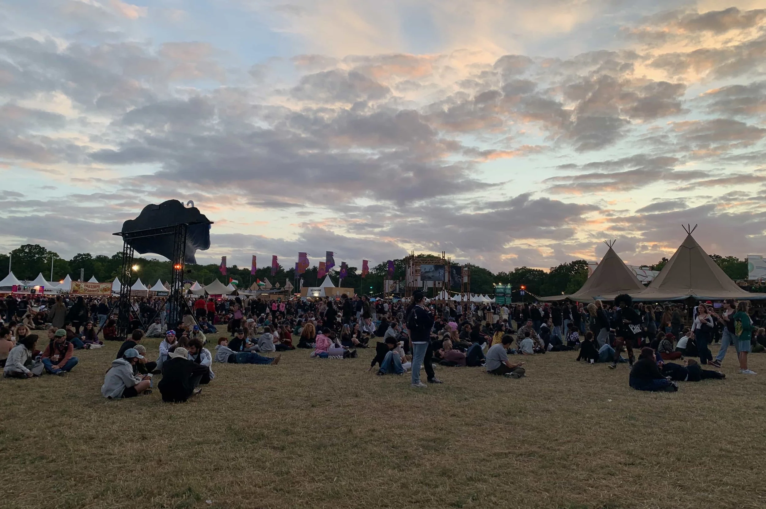 sunset in bois de vincennes paris during we love green music festival lots of people and huts