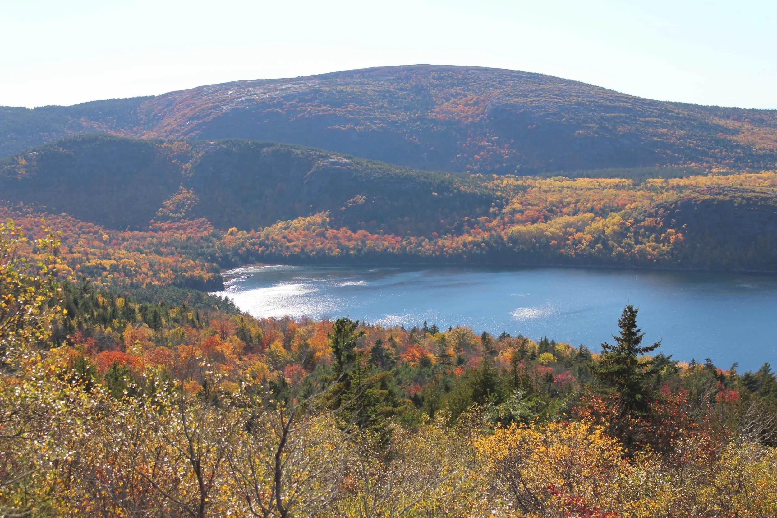 hilly fall foliage lots of colors and glossy lake