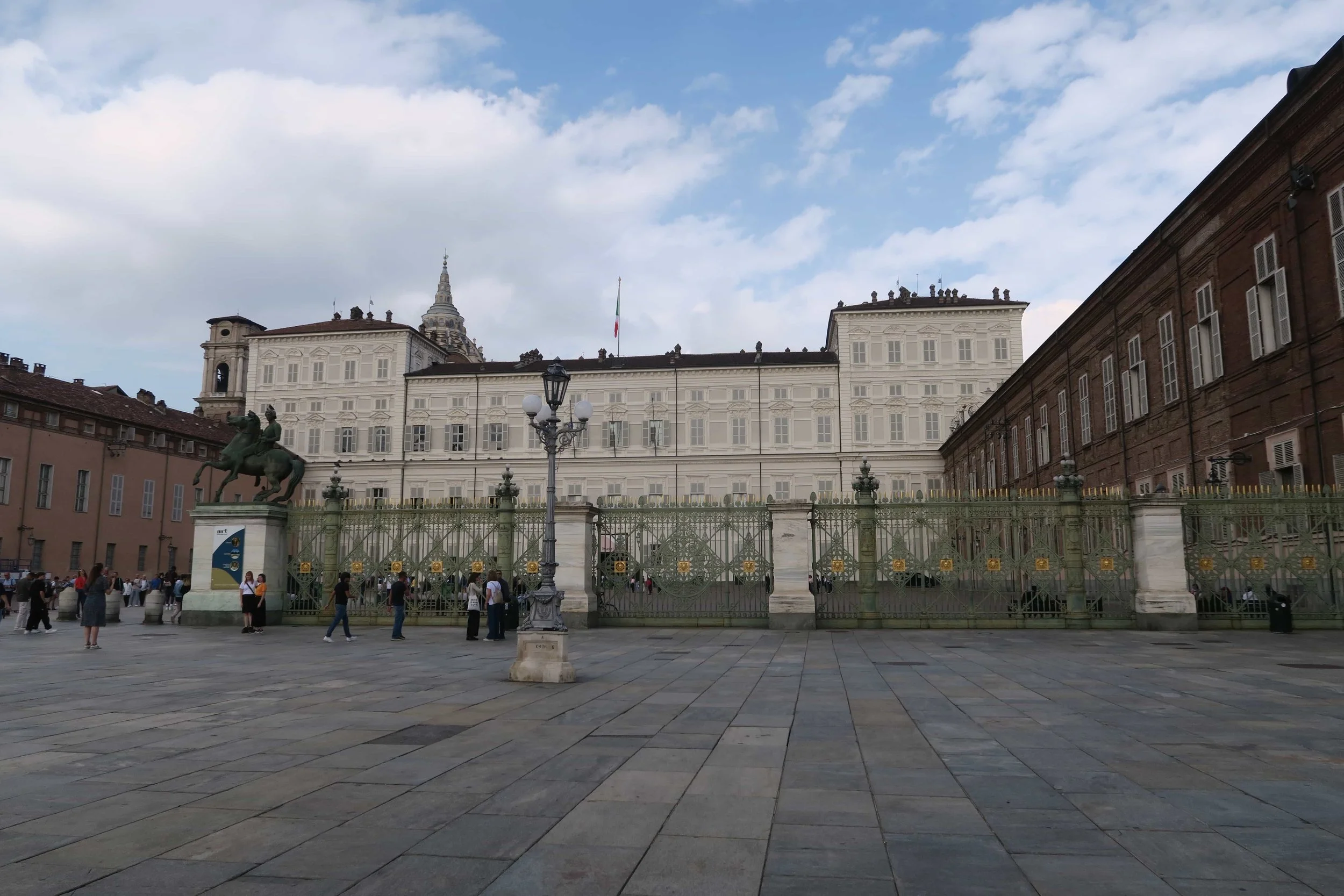 palazzo madama white building with green iron gate fence