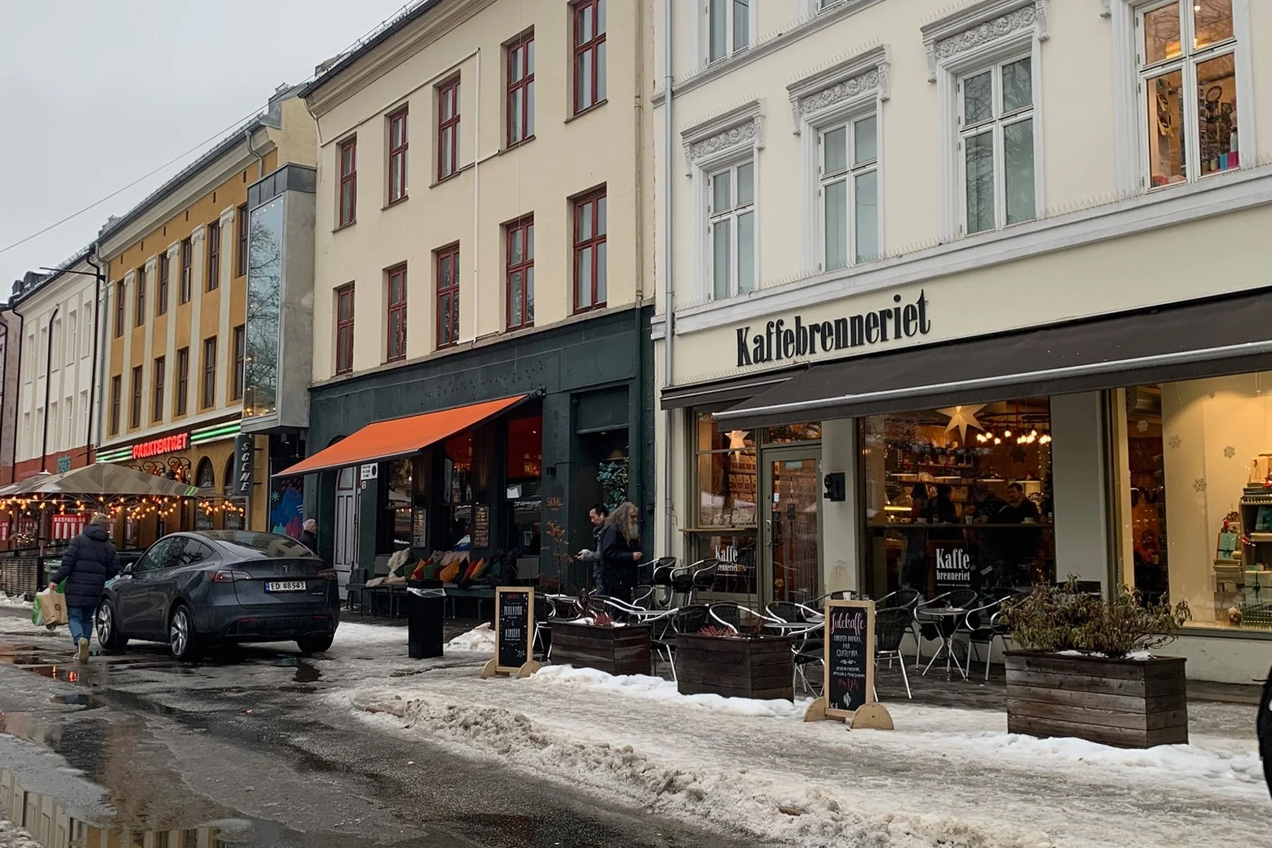 street with cafes in oslo with melting snow