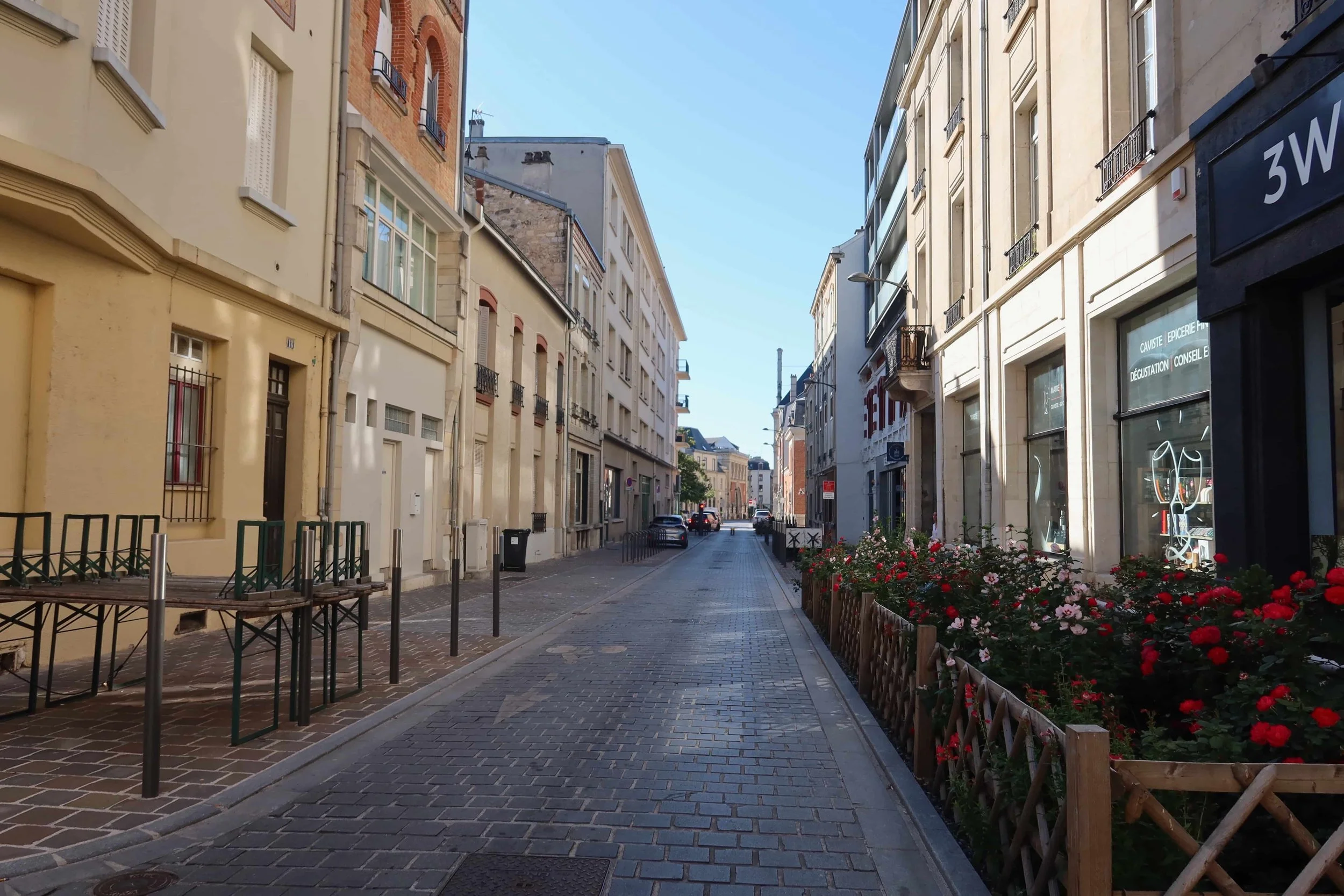 empty street with roses and sunlight on windows