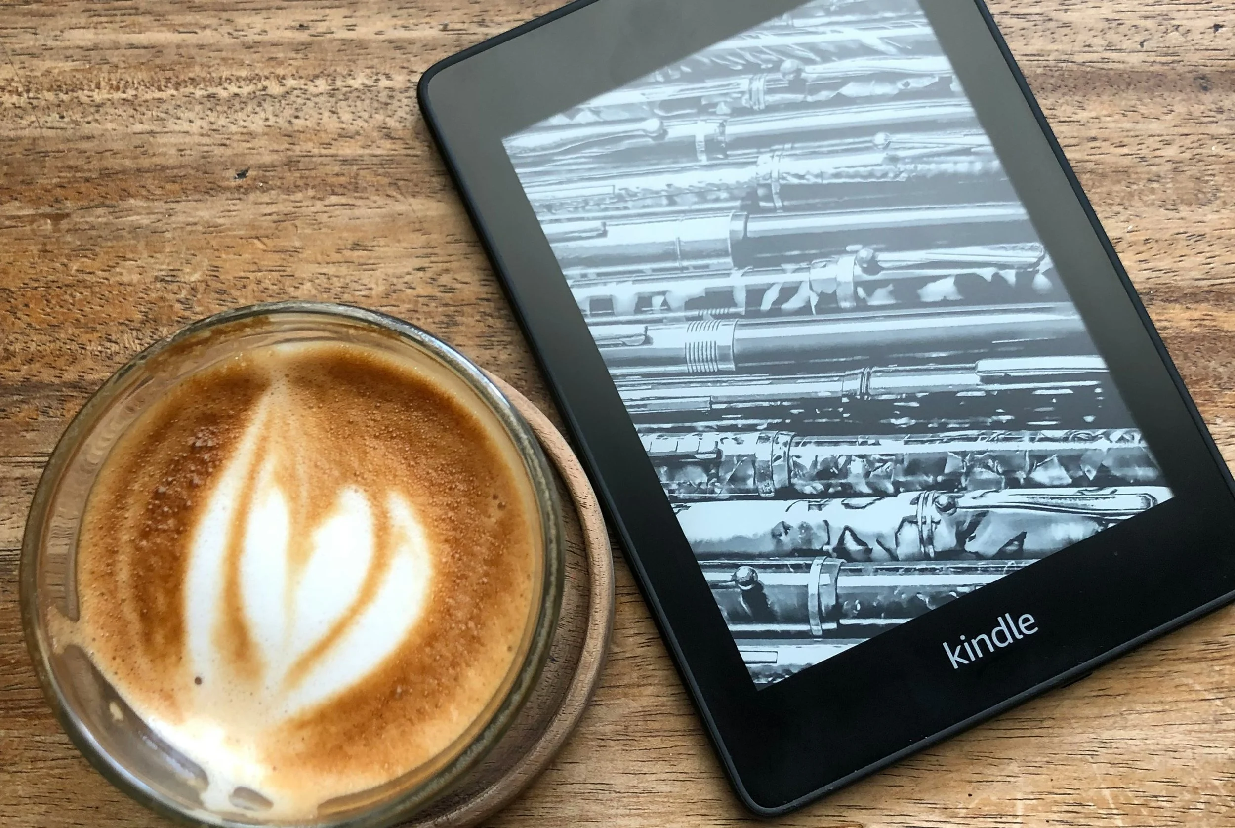kindle next to cup of coffee