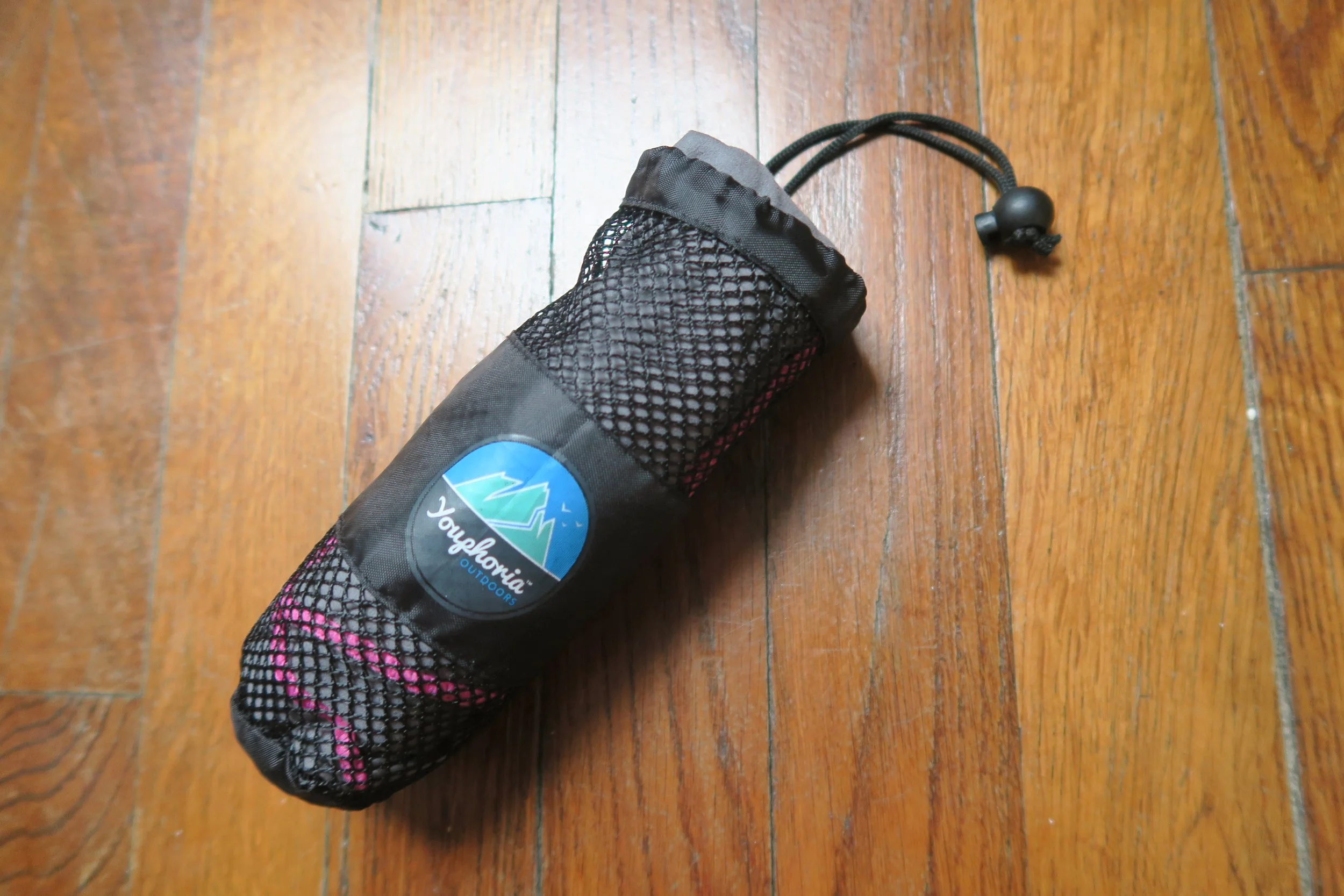 little grey and pink towerl in black fishnet case