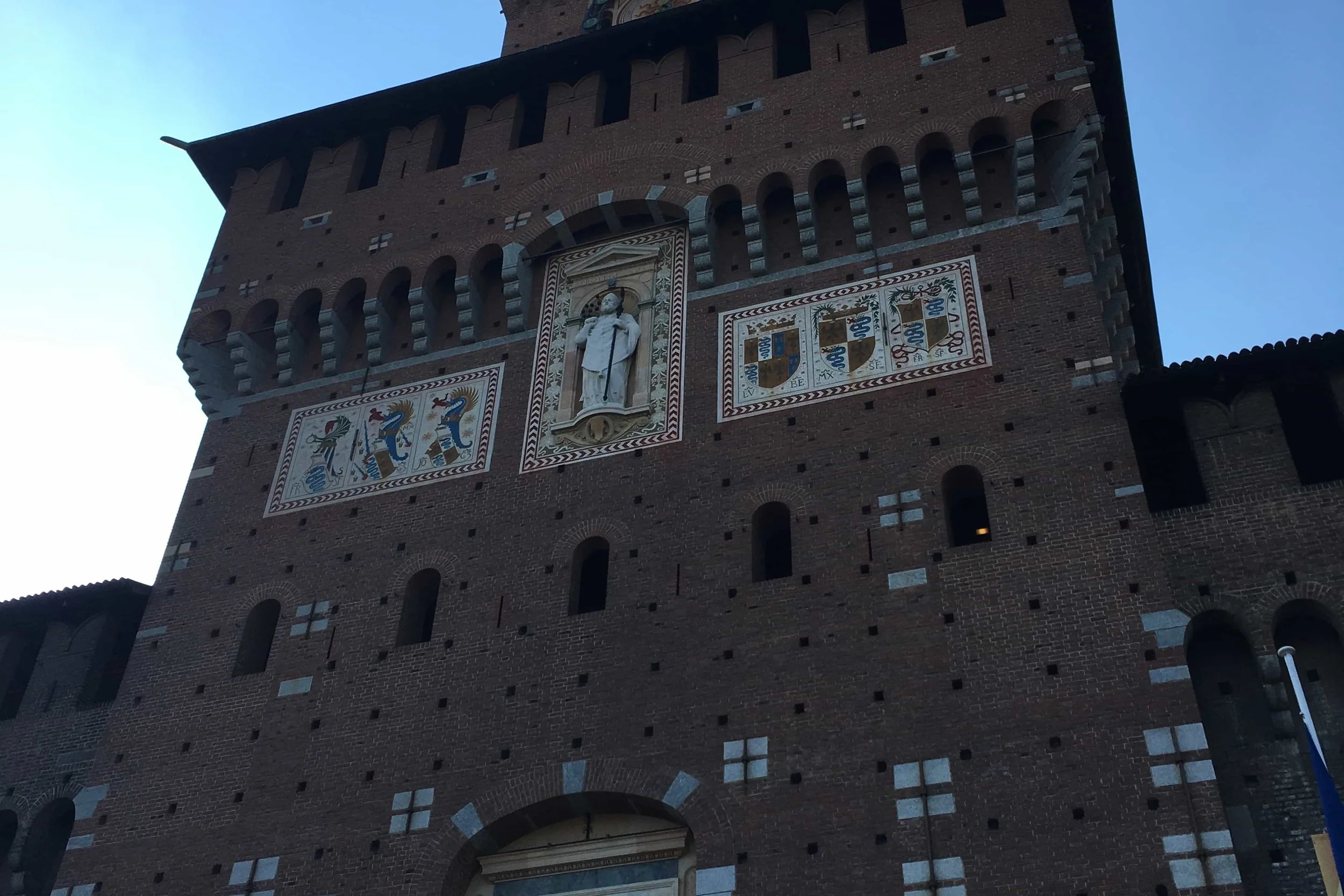brown castle with white statue