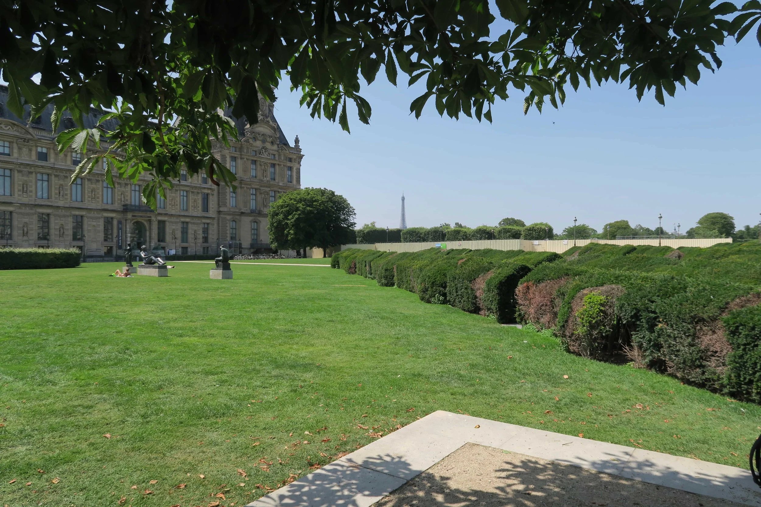 green lawn with eiffel tower in the distance
