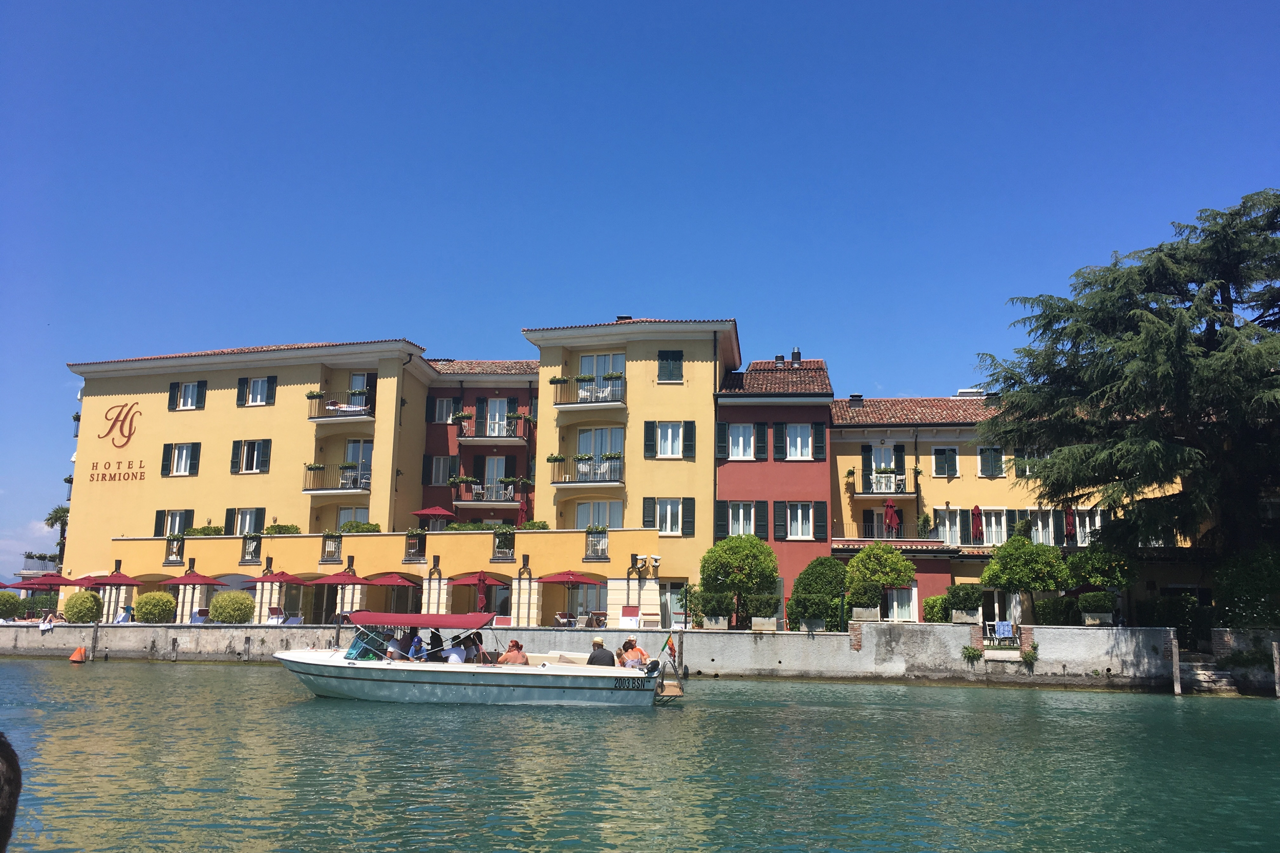 hotel sirmione in lake garda yellow building