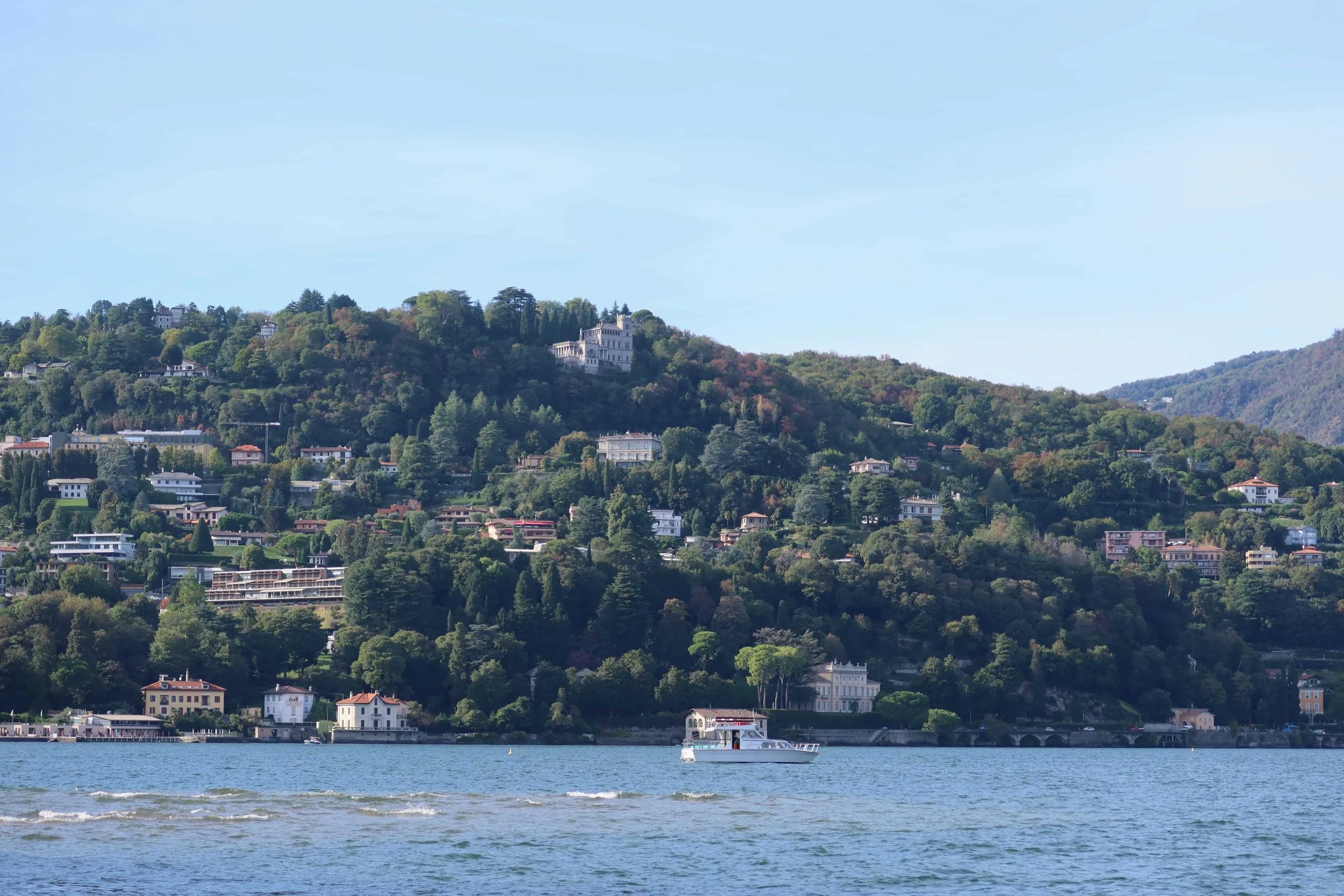 boats and houses on bushy green hills