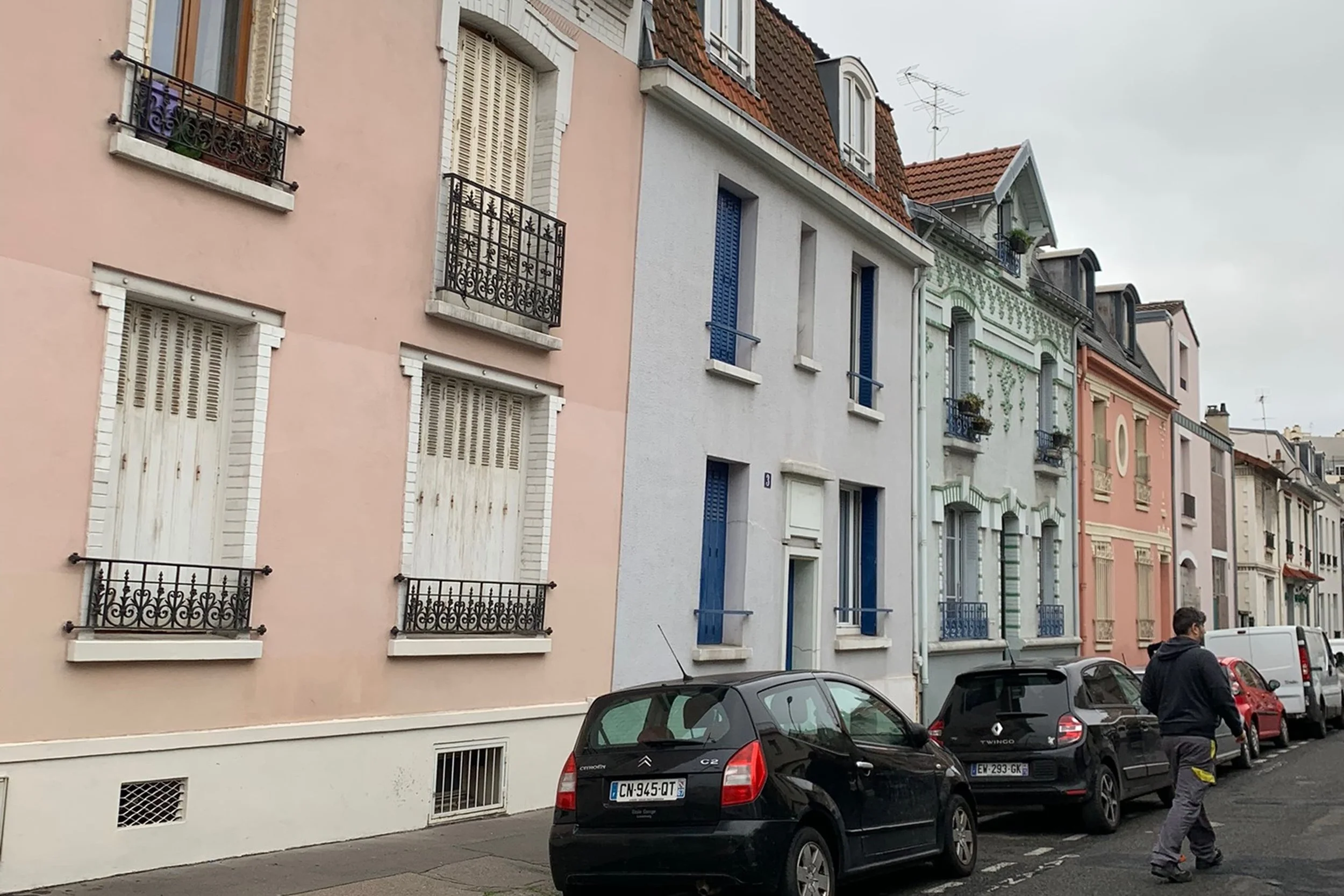 colorful houses paris black cards parked on side