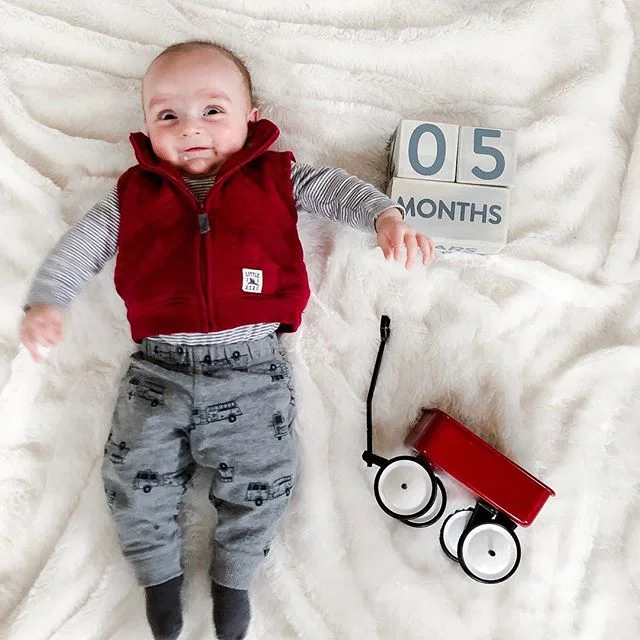 Months four and five are gone just like that and a lot has happened! We are constantly sizing up in all your clothes. You&rsquo;ve rolled over both ways, but only when you feel like it. We&rsquo;ve started introducing foods and you really seem to rea