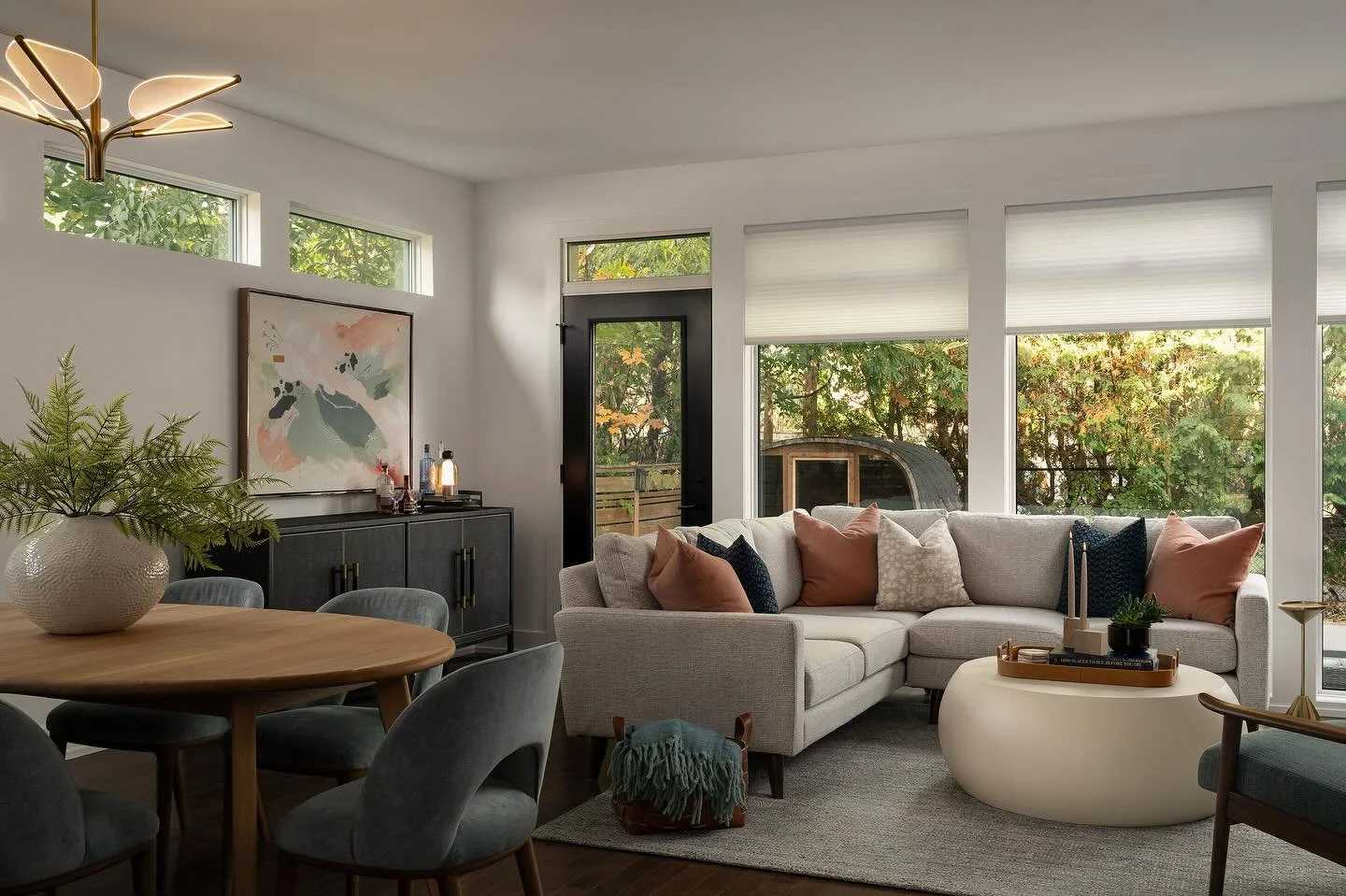 This living + dining space was a complete fresh start ✨ My clients moved from a small condo and needed every inch to feel intentional, comfortable, and beautifully cohesive. We sourced every piece &mdash; lighting, furniture, art, and all the layers 