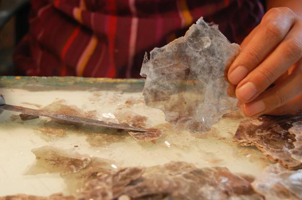 Slicing thin sheets of New Mexican mica in preparation for use in a painting