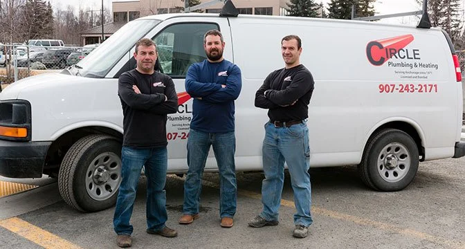 HVAC expert plumbers in front of HVAC truck