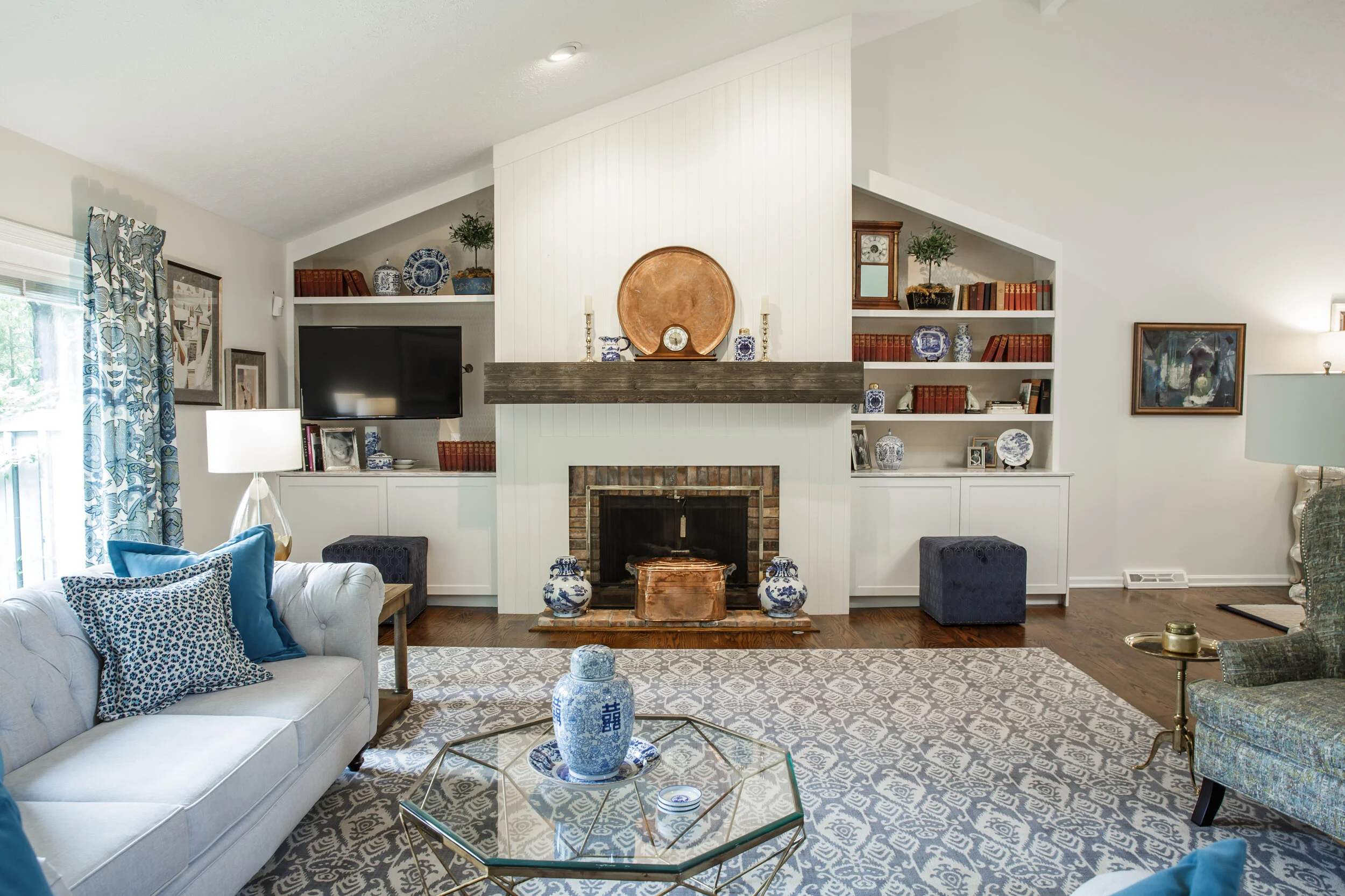 The updated fireplace design provided symmetry to the space &amp; storage in the cabinets. With the application of solid surface stone, we maximized the functionality of the counter for serving when entertaining friends and family.