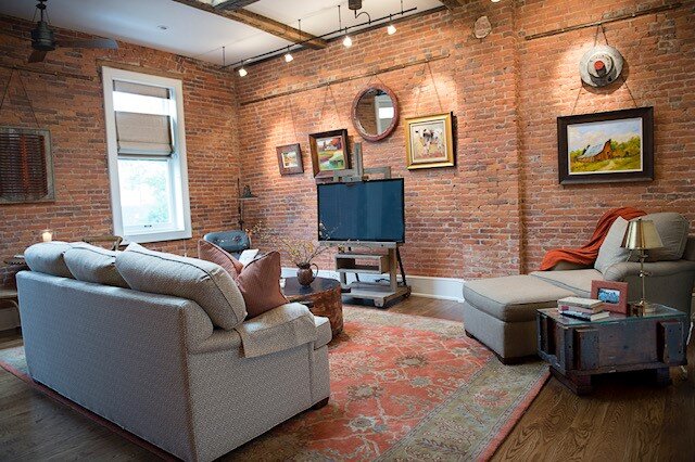 Historical Chagrin Loft Project: an example of mixing different media elements such as original art with a custom mirror and refurbished artifacts from a local factory.