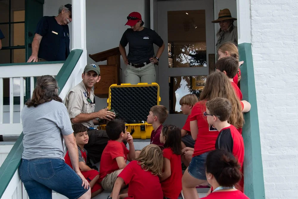 Refuge biologist Jonathan Chandler explains a bat acoustic monitoring system which he is about to install in the lighthouse tower