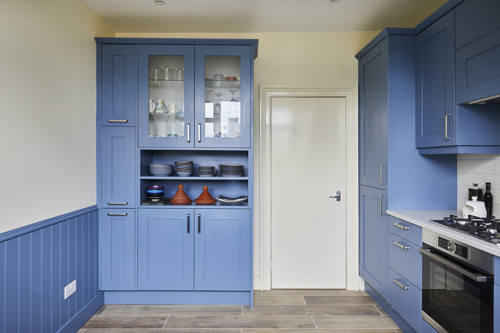 Larder cabinet area designed bespoke to a shallower depth, along with tongue and bead wall panelling in matching paint - to accommodate customers' dining table and protect walls from chair backs.