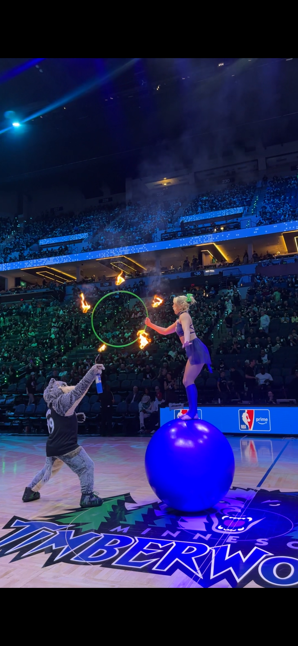 Grace Good performing fire hula hoops at the Minnesota timberwolves NBA playoffs halftime