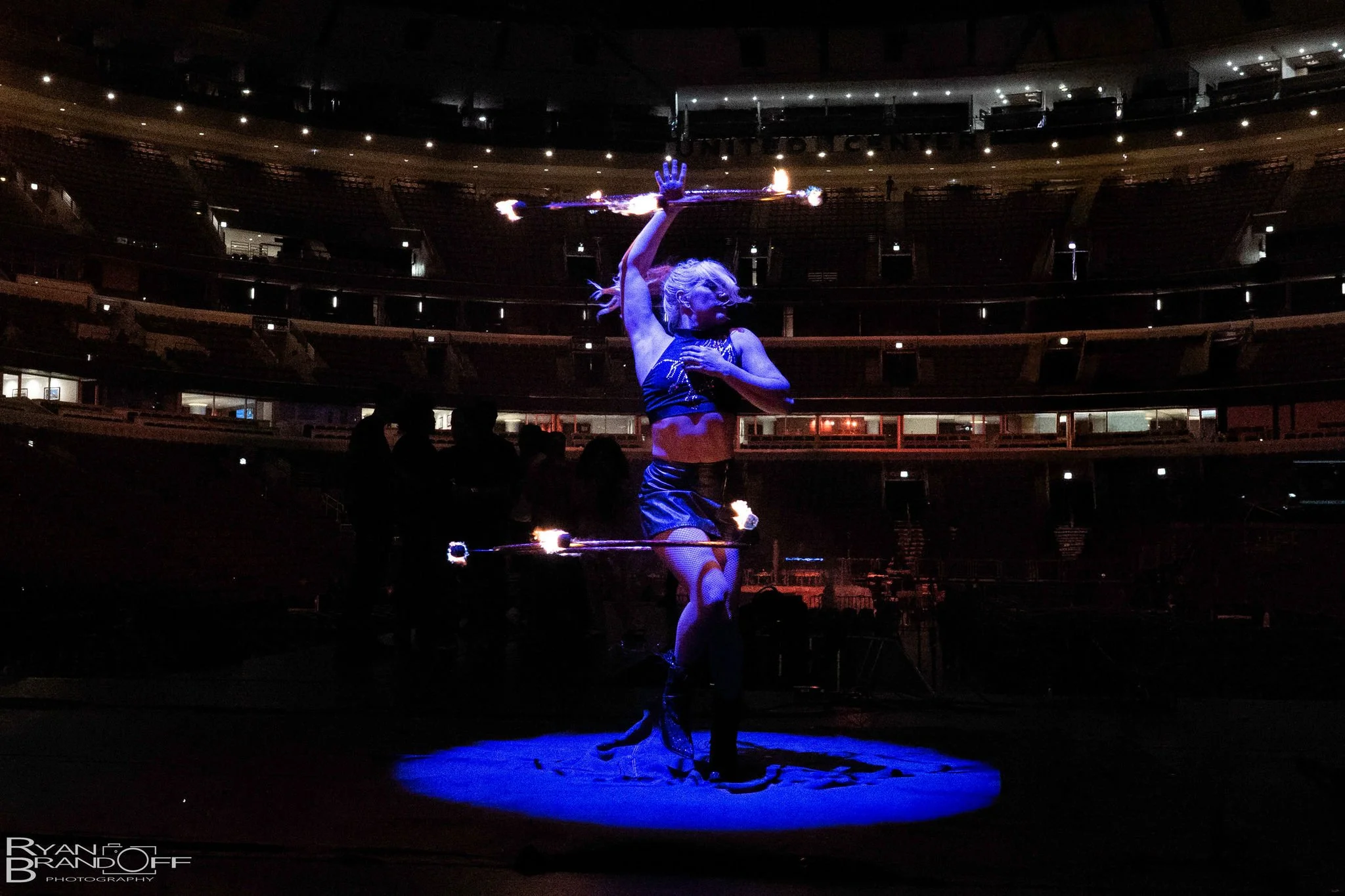 Grace Good performing fire hula hoops during a Summer Walker tour appearance.