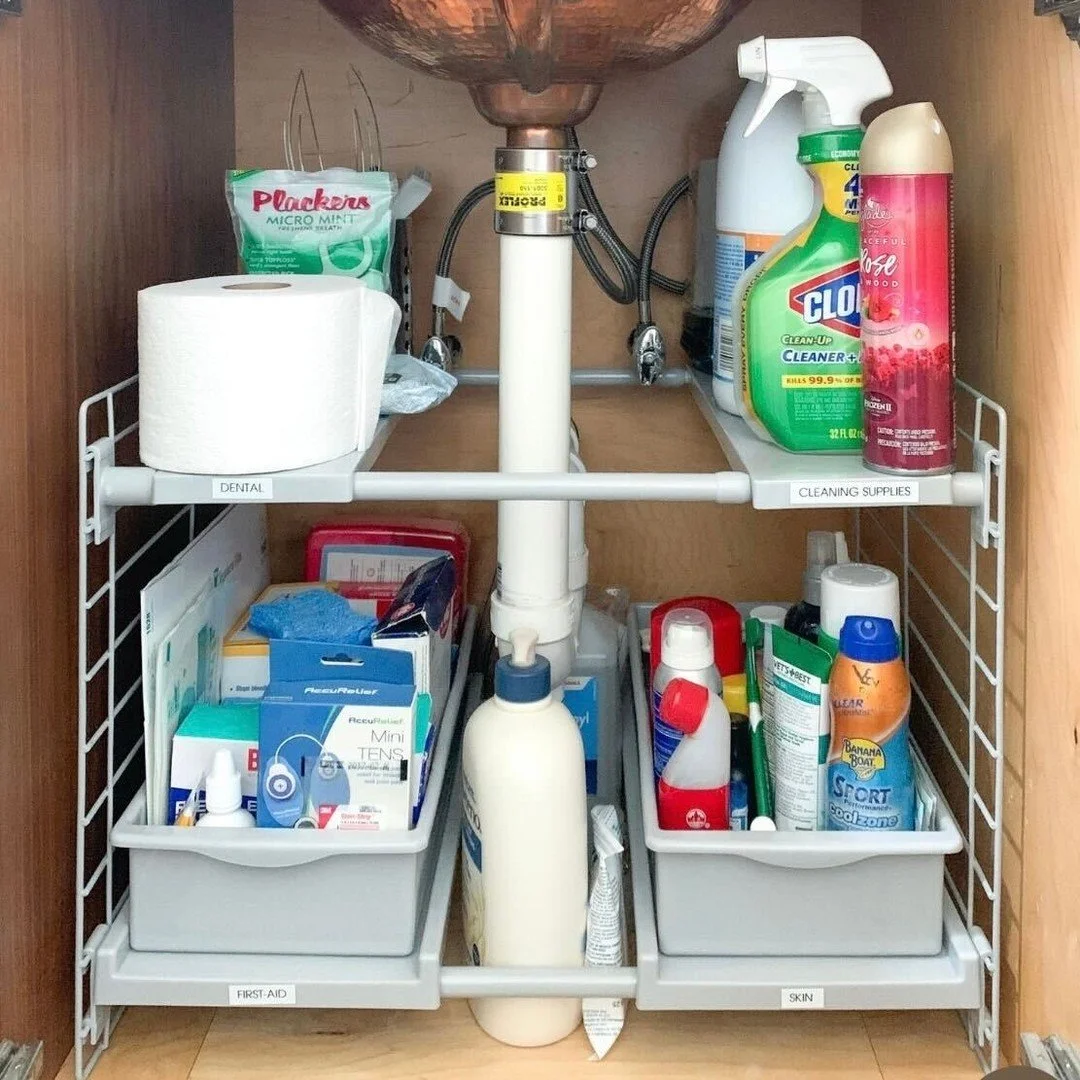 Make the most of every inch under your sink. Vertical shelves and clear bins turn awkward plumbing into a tidy storage zone for cleaning supplies and everyday essentials.