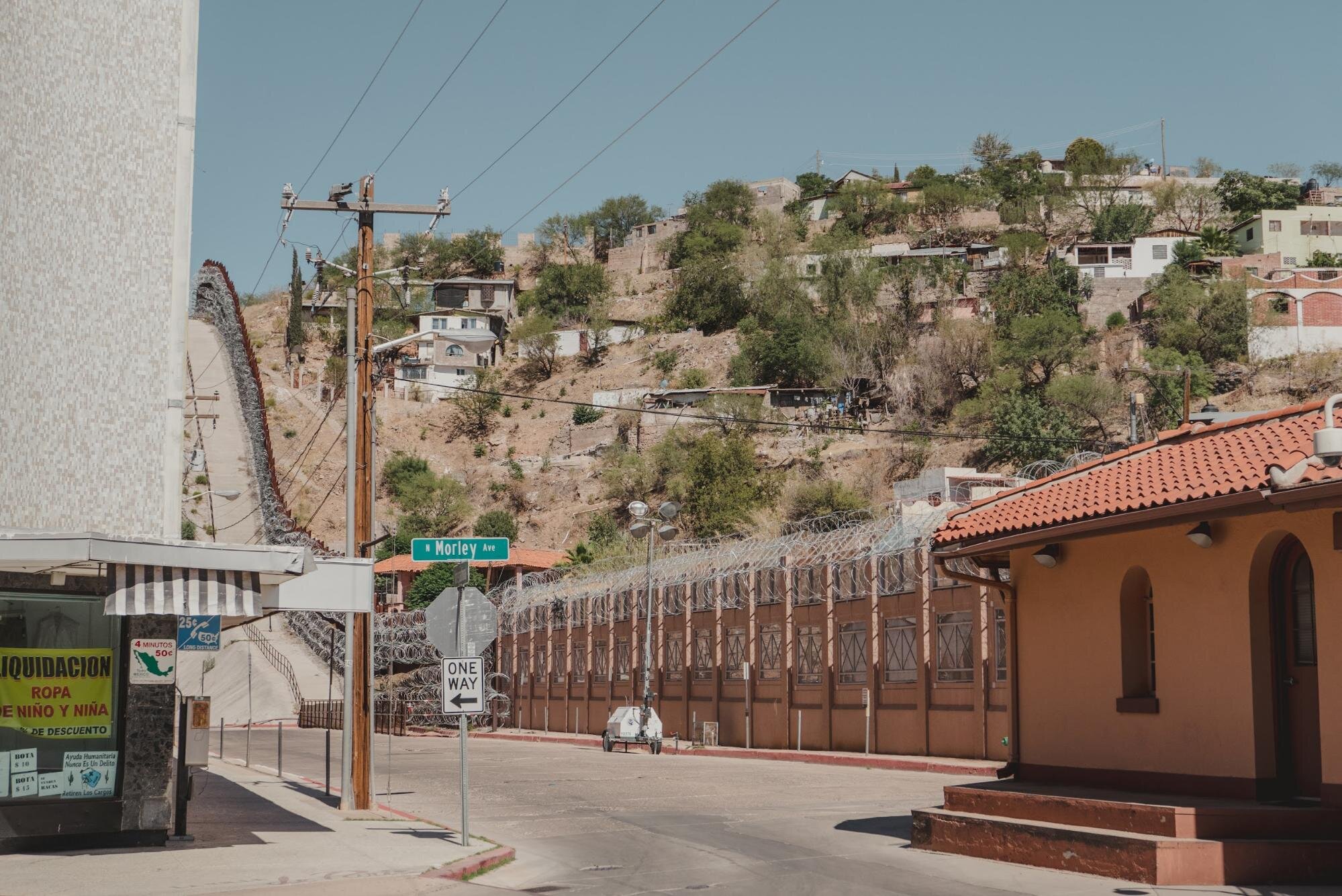   The border wall as seen from the Morley pedestrian port of entry in downtown Nogales, Arizona.To the right is Nogales, Sonora. Photo by Martiza L. Félix  