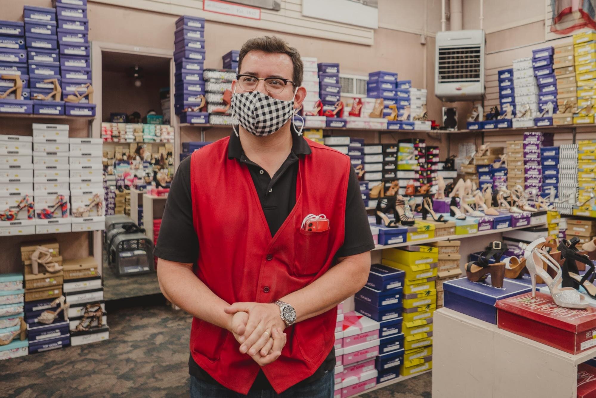   Gregory Kory stands in the middle of La Cinderella store in downtown Nogales, Arizona. Shoes and accessories have been accumulating for over a year and a half following the border restrictions imposed by the U.S. Photo by Maritza L. Félix.  