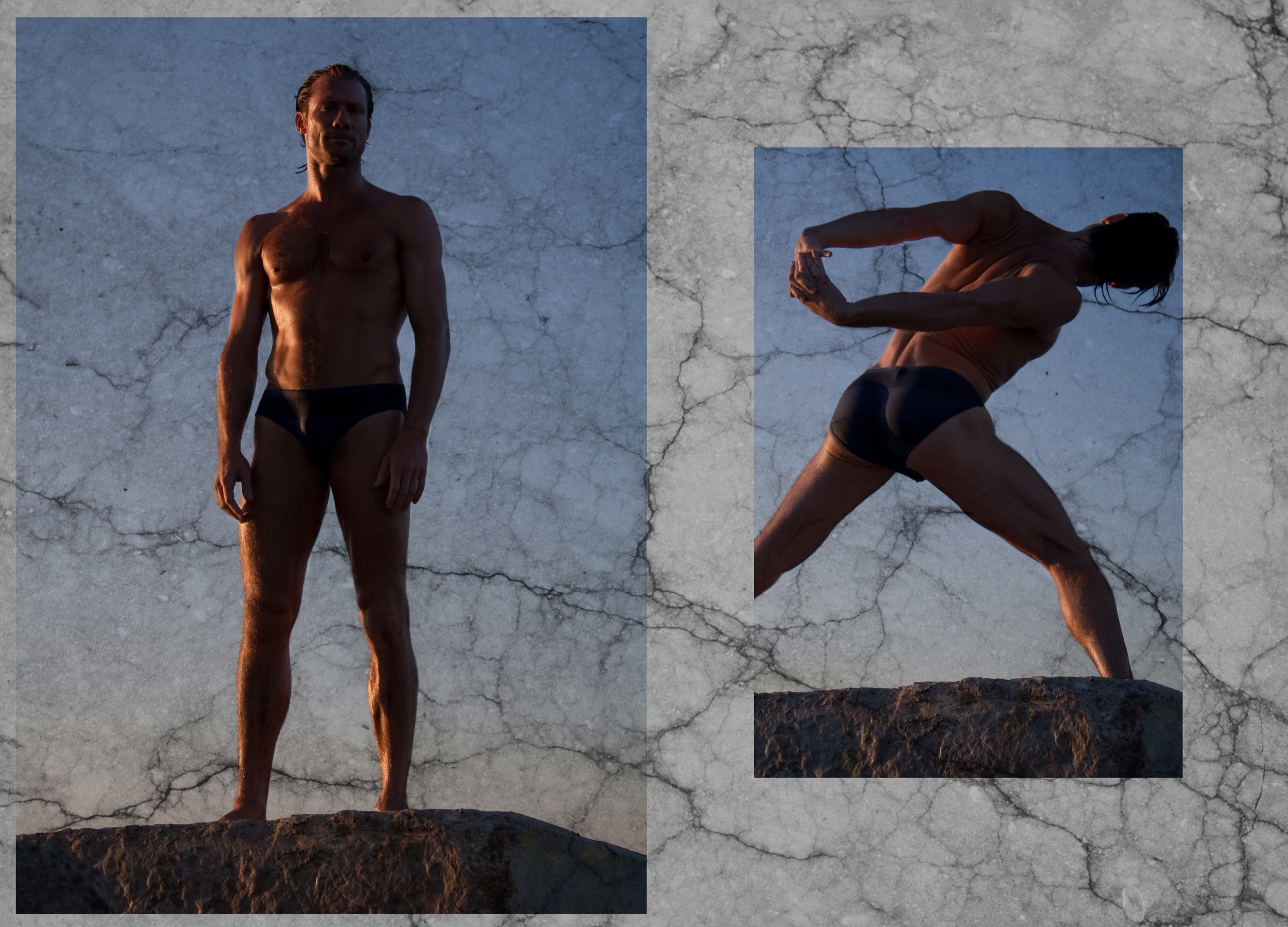 Two shirtless men in black underwear on a rocky surface with a cracked concrete wall background, one standing and one in a yoga pose, during sunset or sunrise.