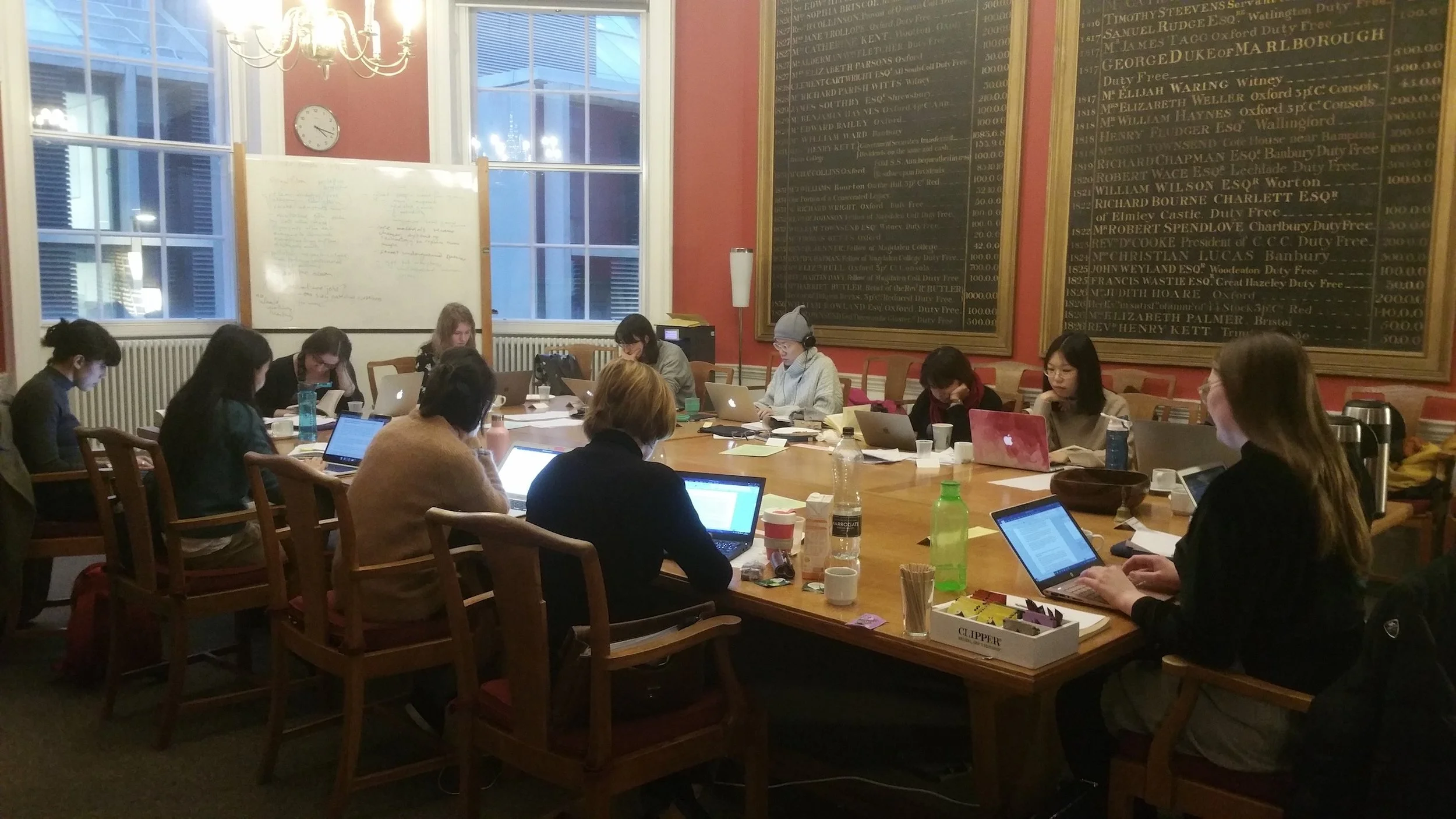 researchers writing around a table at Oxford University