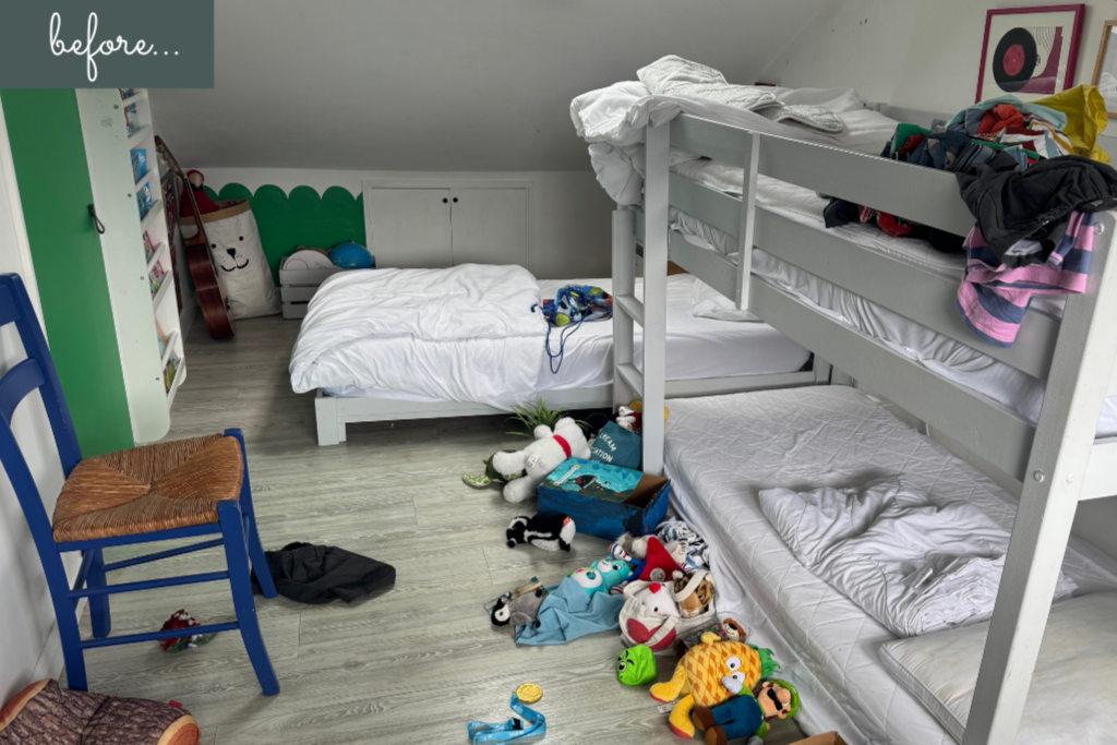 Messy children's room with clothes and toys across the floor.