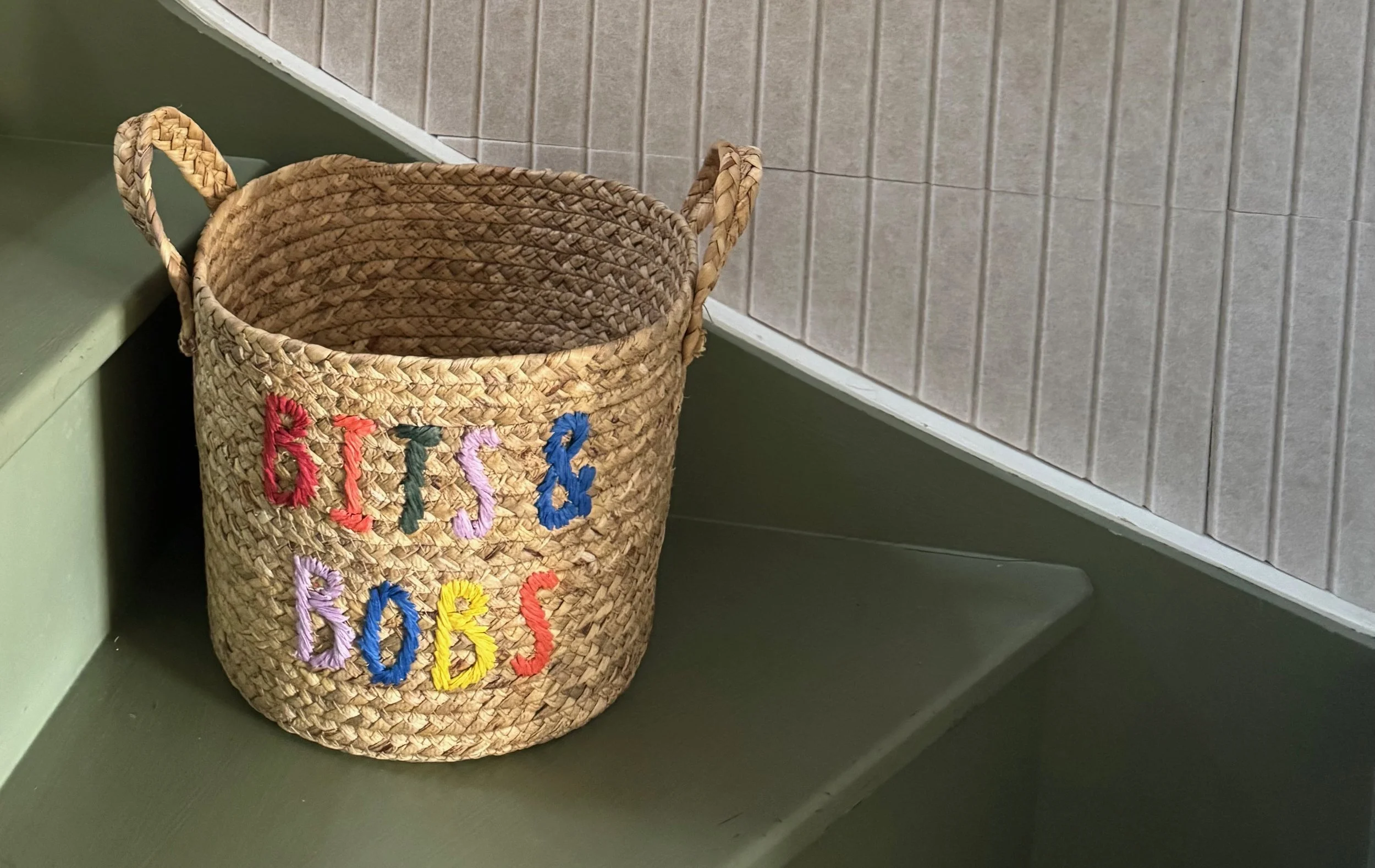 Small basket on green painted staircase