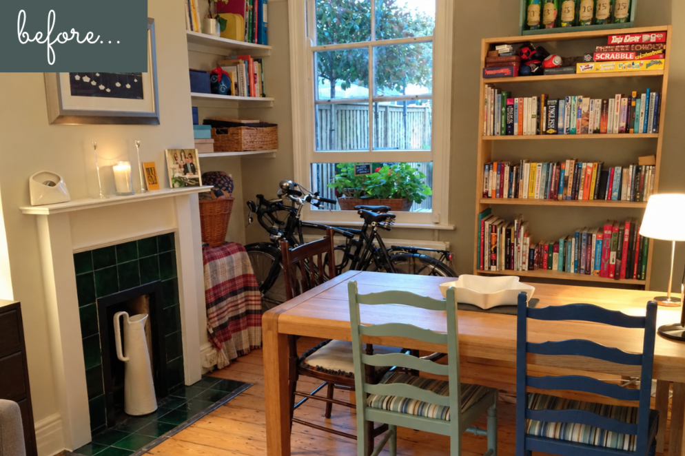 Interior view of table and chairs with bikes propped against the window and large bookcase behind table