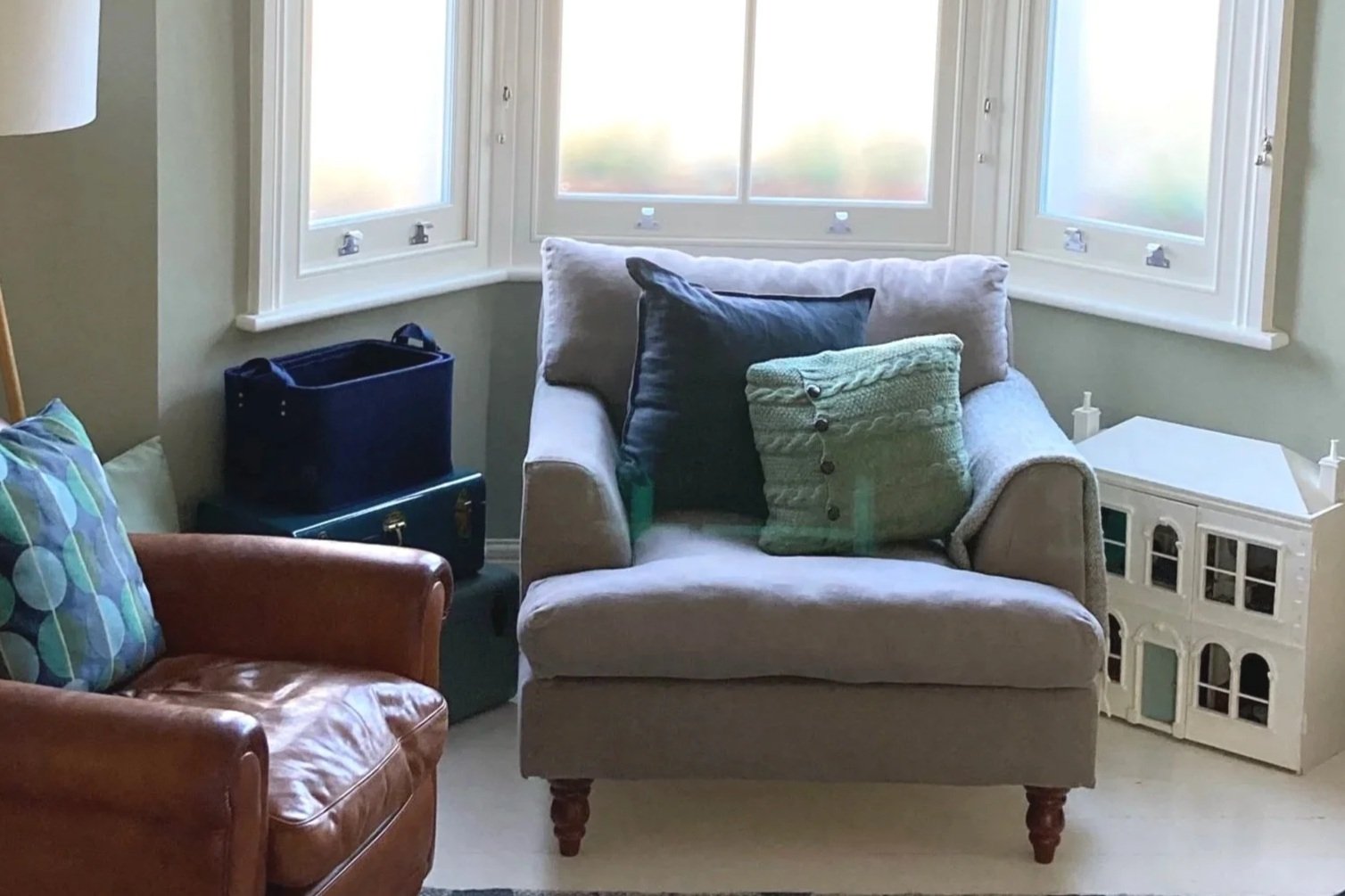 Arm chair and leather chair in bay window